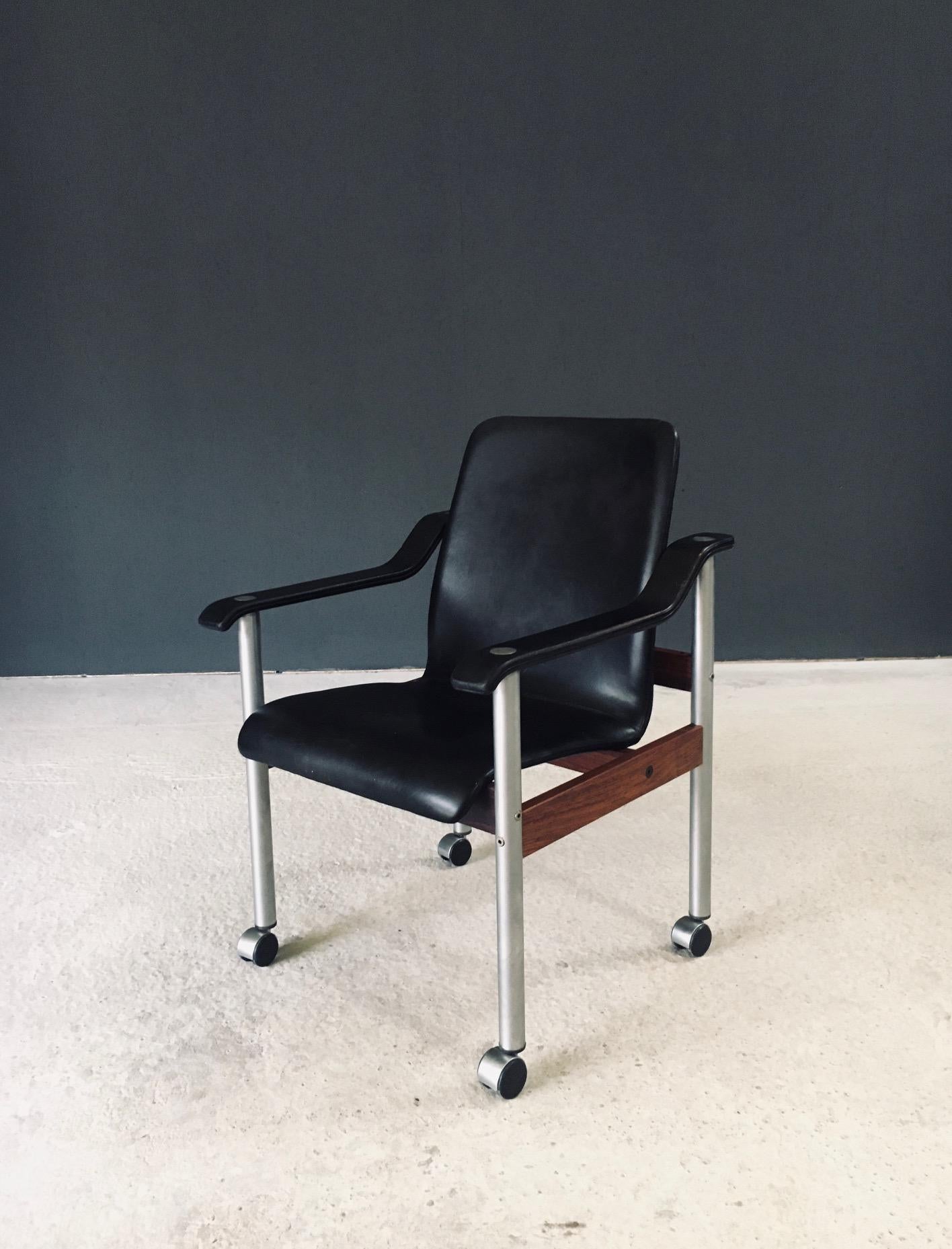 Vintage Midcentury Modern Scandinavian Design Office Chair by Dyrlund. Made in Denmark, 1960's period. Marked with label underneath. Office armchair on wheels/casters. Leather seat and armrests on aluminum and teak wood base. This comes in good,