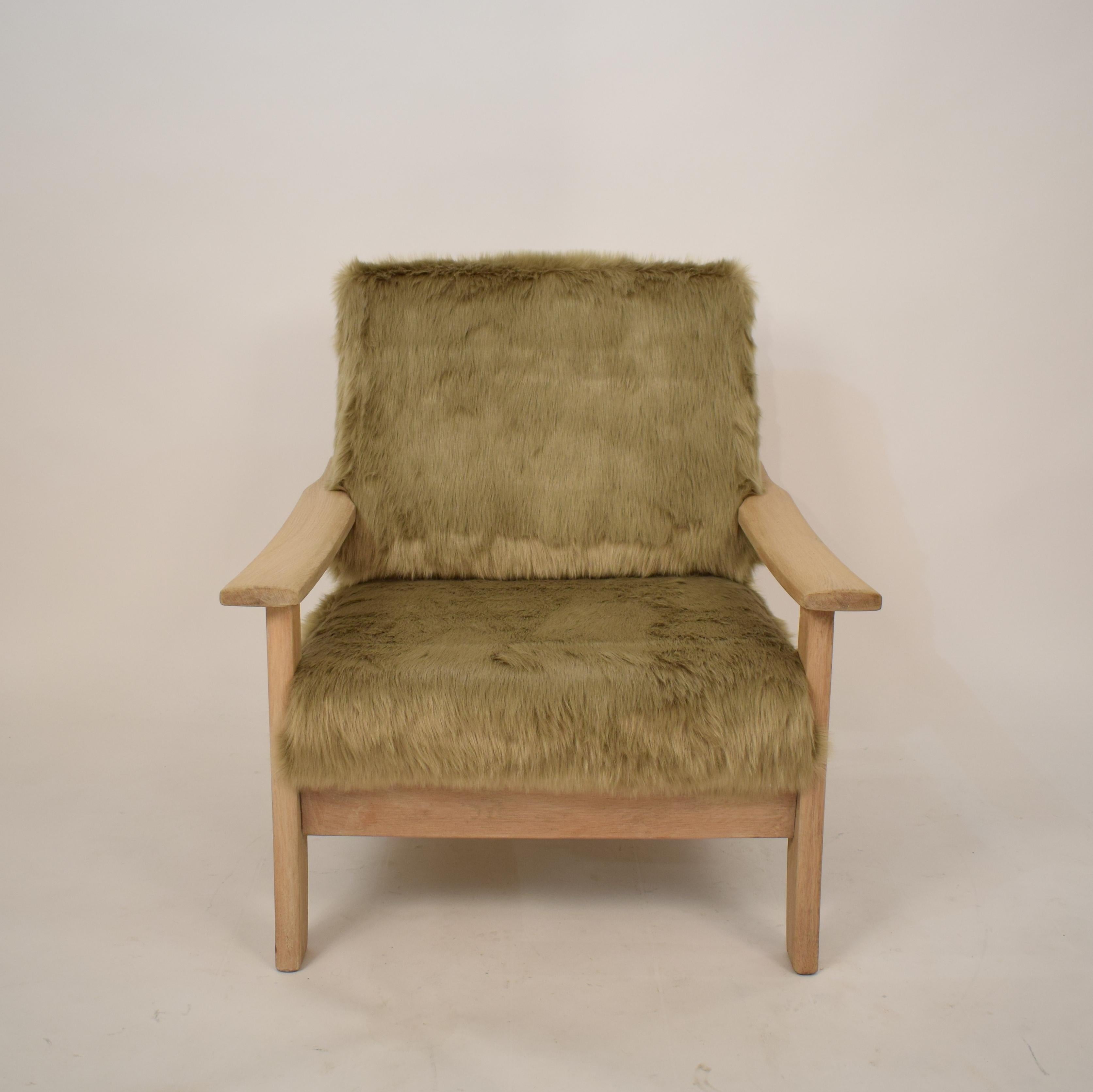 This cool Mid-Century Modern Scandinavian armchair was made circa 1970.
It is made out of solid Light oakwood and was recently 
upholstered in faux fur.
It has this special big foot look!
A unique piece which is a great eyecatcher for your