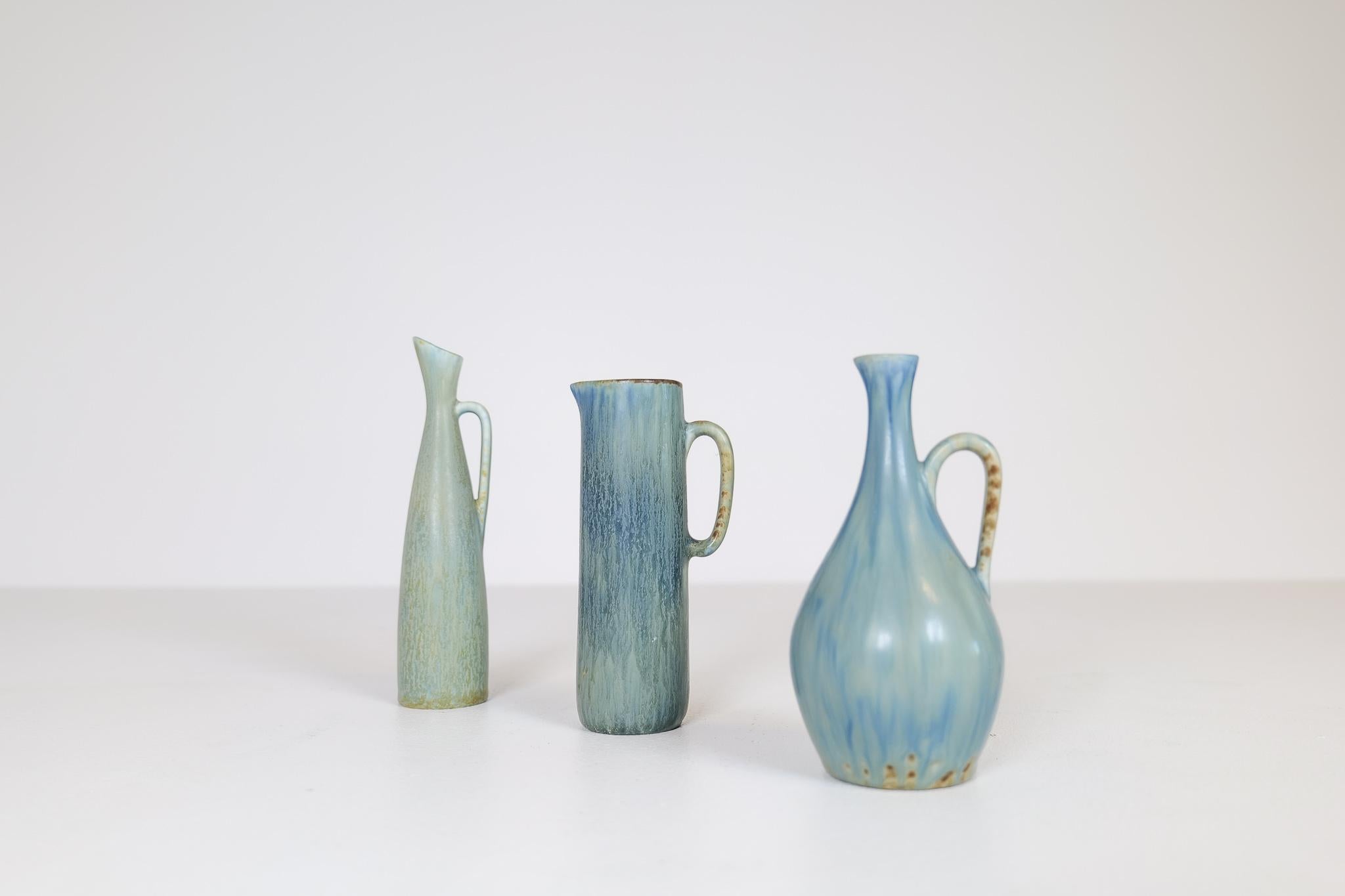 These three wonderful pieces was designed by C.H Stålhane at Rörstrand Factory in Sweden, 1940s-1950s. Their exceptional shape together with their stunning glaze gives this three vases / pieces life and are suitable for many places in the modern