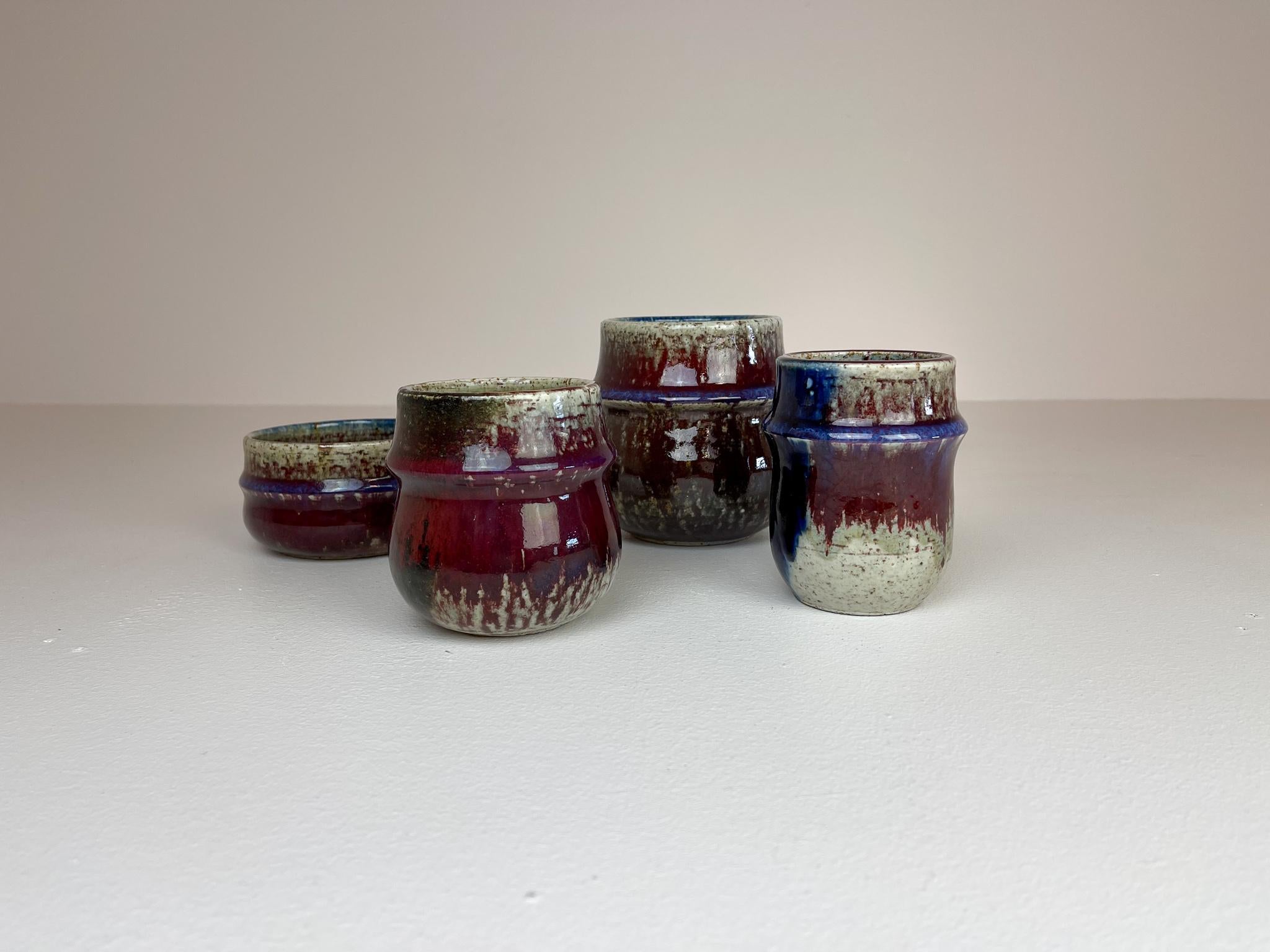 This set containing 4 pieces ceramic was designed by Sylvia Leuchovius and produced by Rörstrand. These four pieces are marked as studio ceramic and are well sculptured with a stunning glaze. They all shift in color as the glaze give them all that