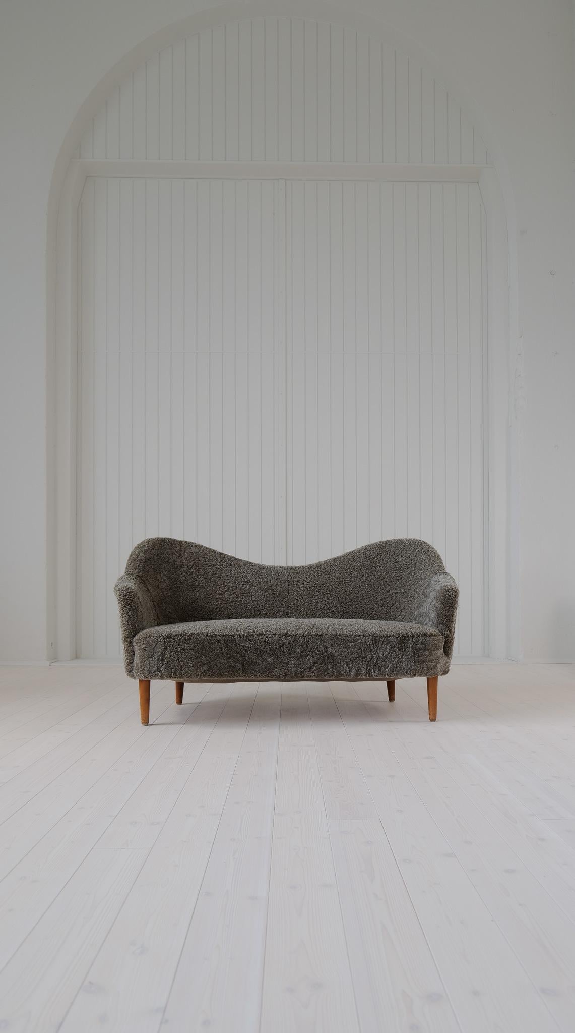 This model” Samspel” sofa was designed by Carl Malmsten in 1956 and manufactured during that time at AB Record Bollnäs Sweden. The sofa has been fully reupholstered and now have its beautiful famous lines made in 
