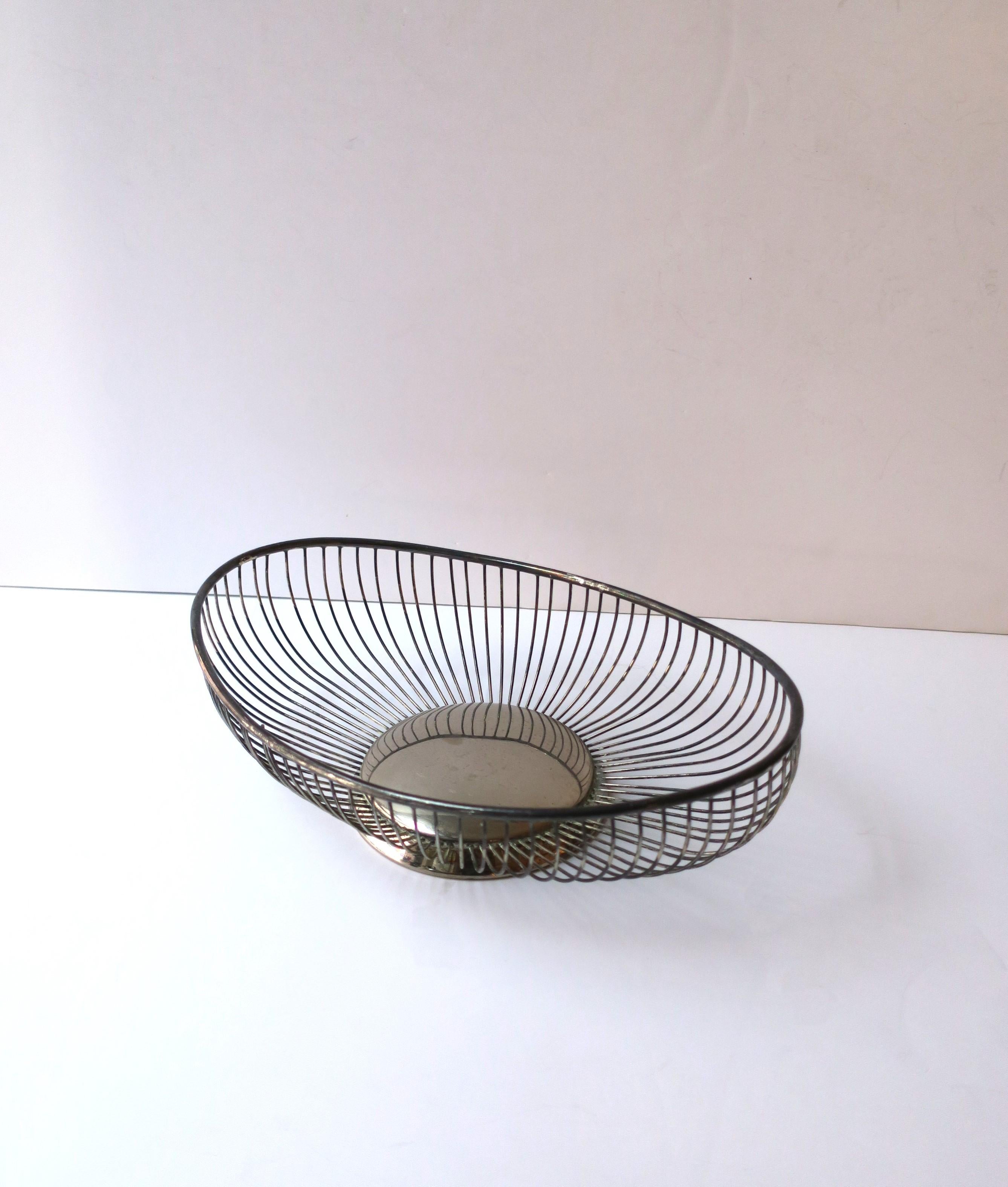 A beautiful sterling silver plate oval wire basket, Midcentury Modern period, Italy. A great basket for bread, fruits, vegetables, etc., or as a standalone piece. Dimensions: 7.63