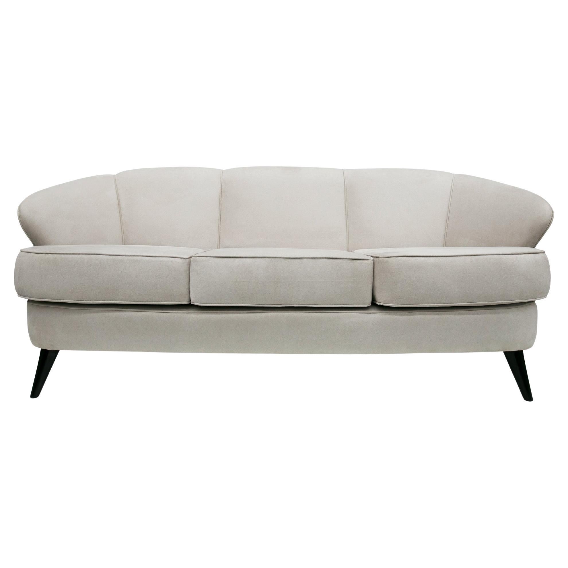 Available right now, this Brazilian modern sofa designed by Joaquim Tenreiro in the sixties is gorgeous! The model is called “Concha” (Shell in portuguese) and the sofa features a hardwood structure, upholstered seats in gray velvet, and four
