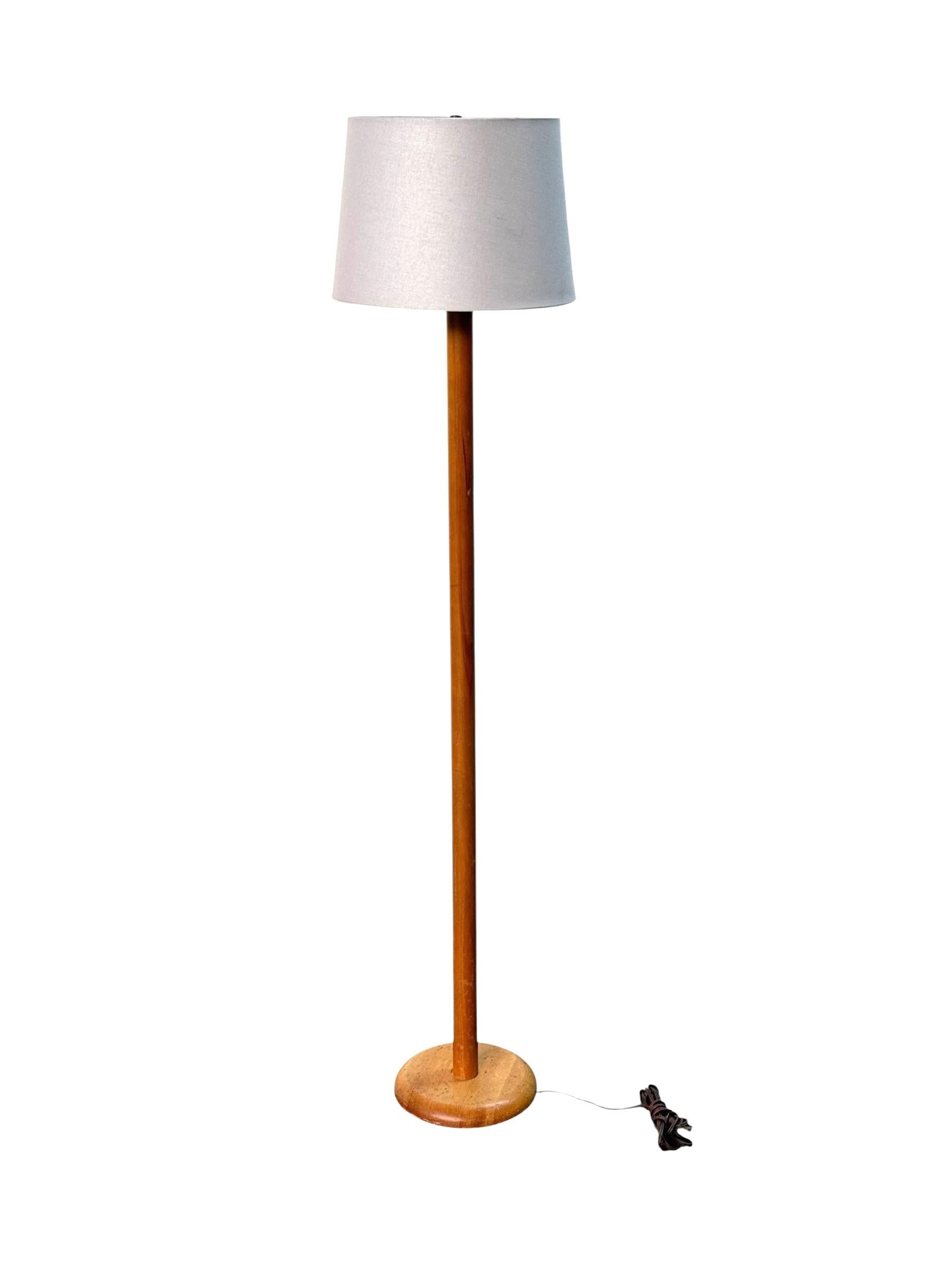 Simple and handsome Midcentury modern floor lamp. Executed in solid blonde wood with a new linen shade. Tested and works. Accommodates modern style bulbs, as well as traditional incandescent bulbs. Refinishing available for. $99. 