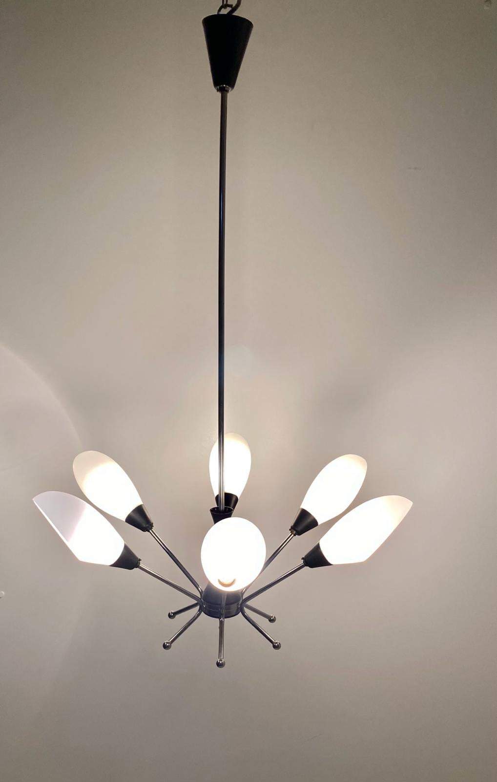 Midcentury modern Sputnik Chandelier attributed to Stilnovo and manufactured in Italy in the 1960 's.

Chromed steel structure and six lights with white opaline glass lampshades. 

Revised and restored from our team, perfectly working. Very good