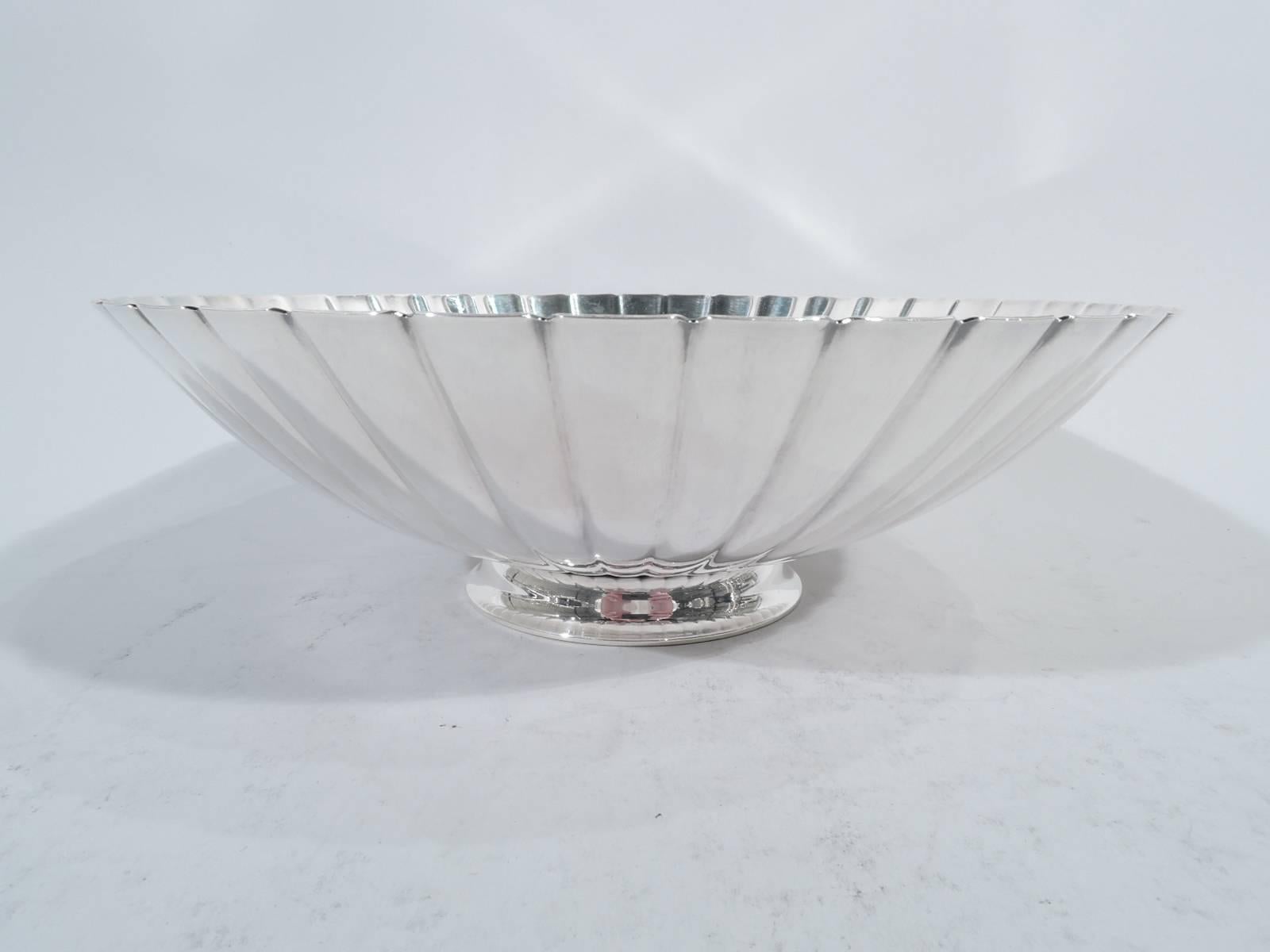 Mid-Century Modern sterling silver bowl. Made by Georg Jensen in Copenhagen. Round and shallow with plain well radiating flutes. Postwar hallmark includes designer’s stamp Sigvard Bernadotte and no. 856A. Weight: 15 troy ounces.