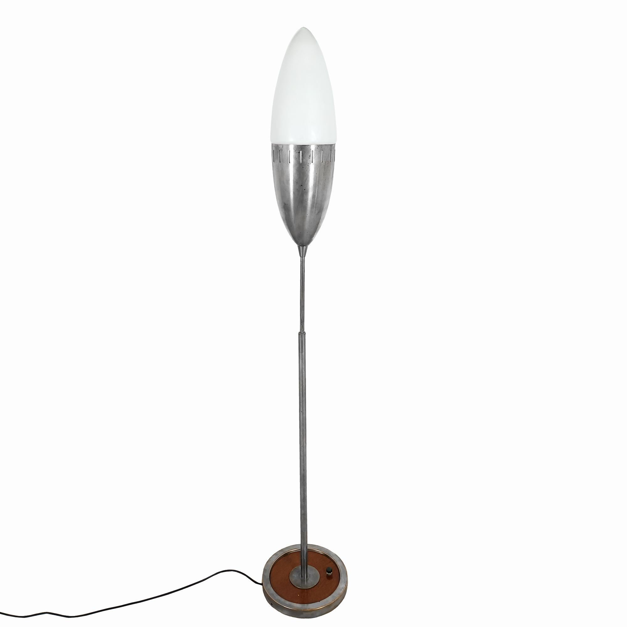 Lampe sur pied Stilnovo, base ronde en chêne et laiton nickelé, interrupteur d'origine, longue tige se terminant par un ovale allongé, moitié en laiton nickelé, moitié en verre opalin.

Italie vers 1950.