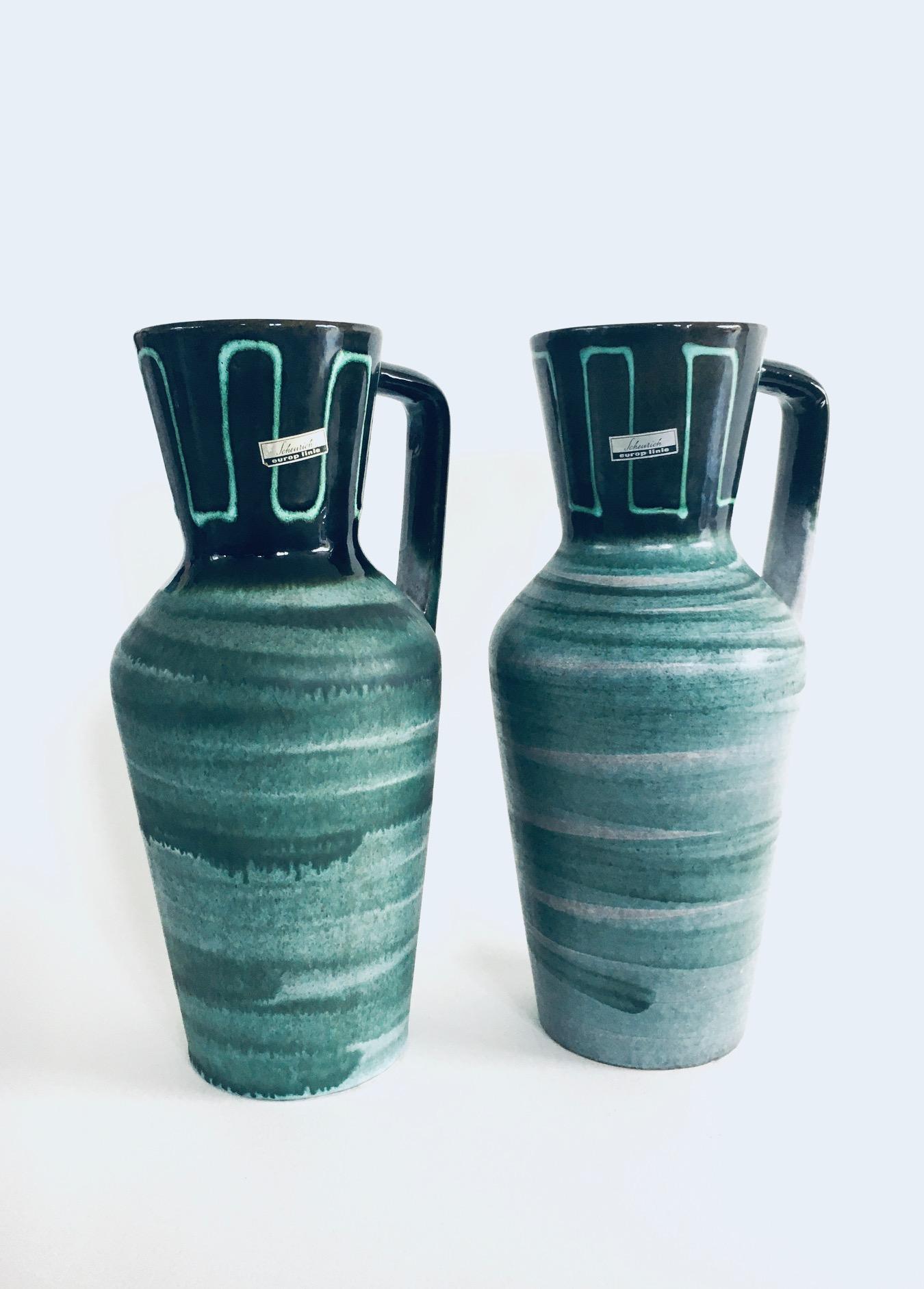 Vintage Midcentury Modern Art Studio Pottery Jug Vase set by Scheurich Europ Linie, West Germany 1960's. Model 407-35. Dark to light green glazed pot. In very good condition. Each vase measures 18cm x 15cm x 35cm. 
Sold as a set of 2