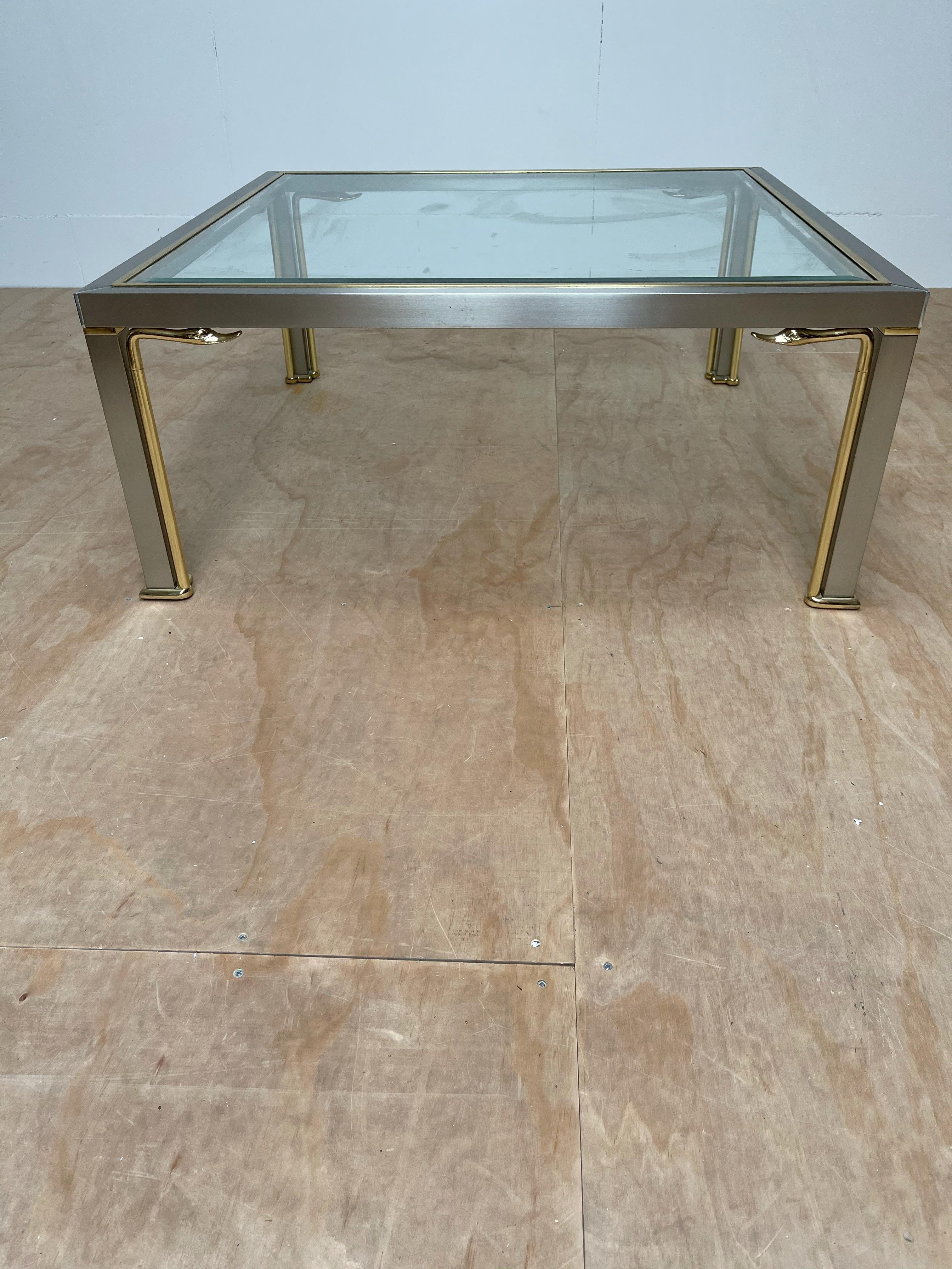 Good size, practical and very decorative square coffee table.

This beautiful quality coffee table is highly decorative and it comes with some impressive details. The best ofcourse are the eight elegant and stylized, bronze swan heads. Their grace