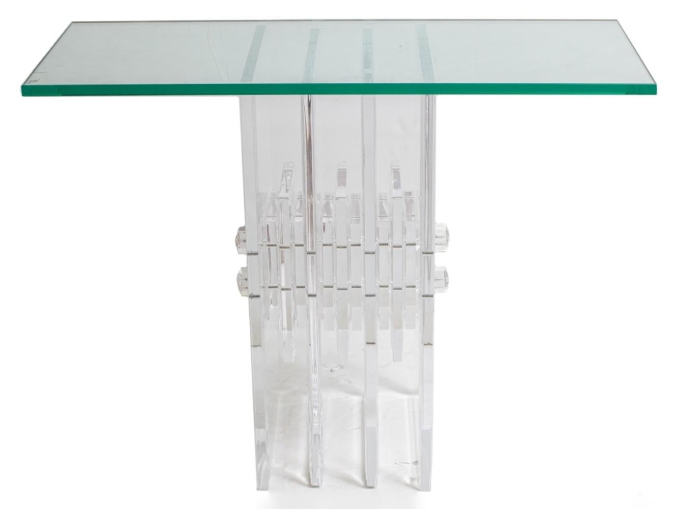 Mid-Century Modern style glass and lucite console in the Karl Springer (German/American, 1931-1991) manner, with a rectangular glass top above the horizontally stacked and conjoined lucite block base. In good condition. Wear consistent with age and