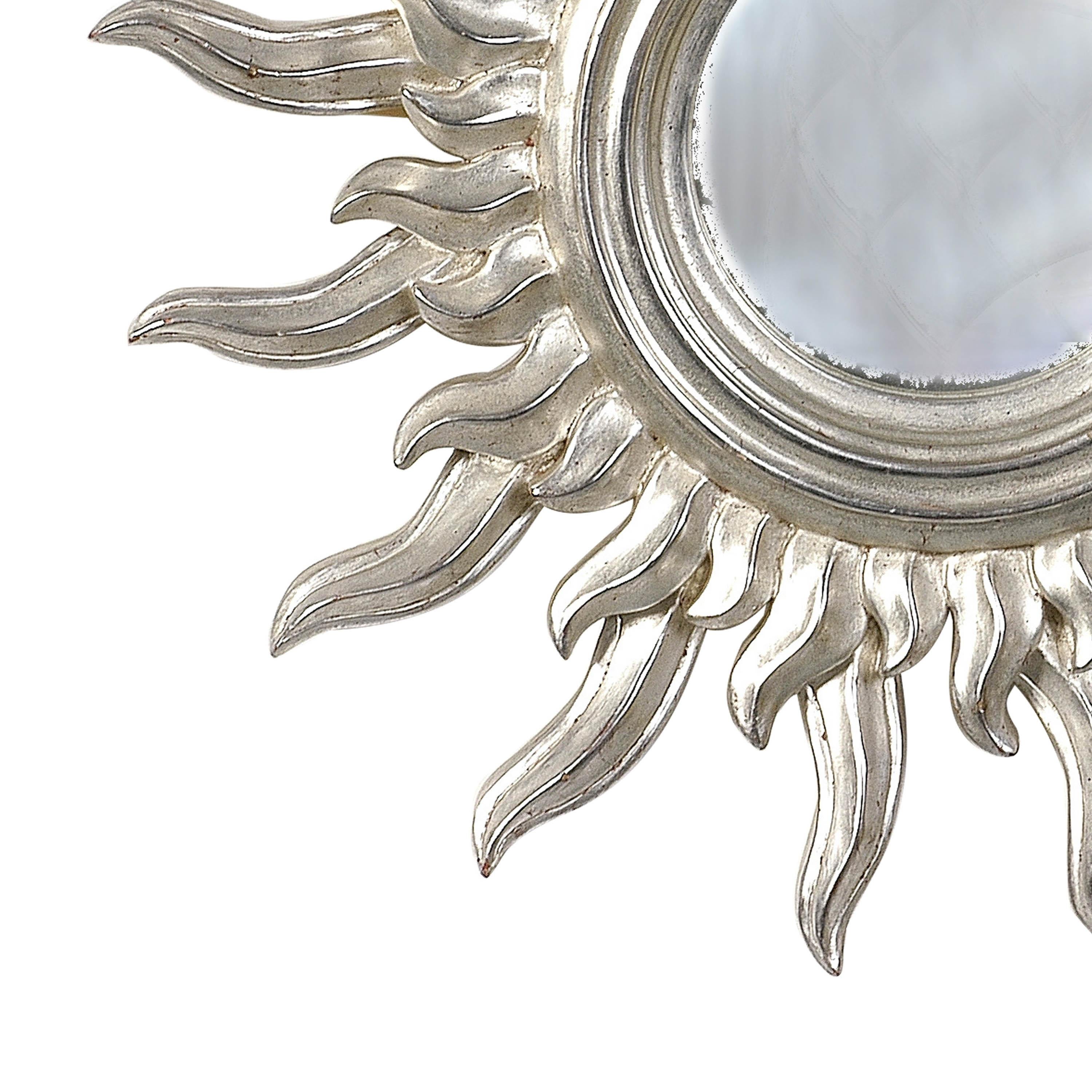 French mirror in the form of sun carved by polychrome hand finished in a silver bath.
  