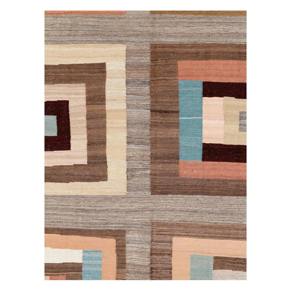 A Mid-Century Modern Persian flat-woven rug handmade during the 21st century. The appeal and texture are very much Swedish/Scandinavian due to the use of the Swedish flat-weave weaving technique that was incorporated into making this room size