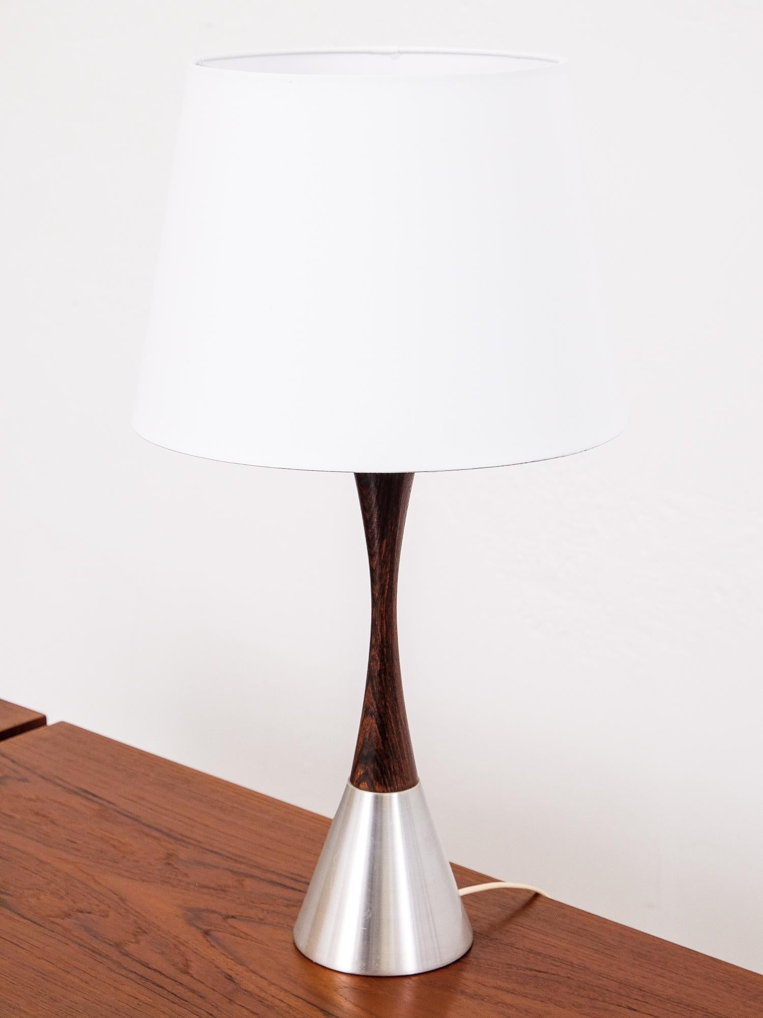 Rare table lamp by Bergboms, Sweden, 1960s. The lamp is made of rosewood and brushed metal. Design of this lamp is simple and elegant and the wood and the metal make a beautiful contrast.

Height with shade 62 cm
Shade diameter 33 cm.