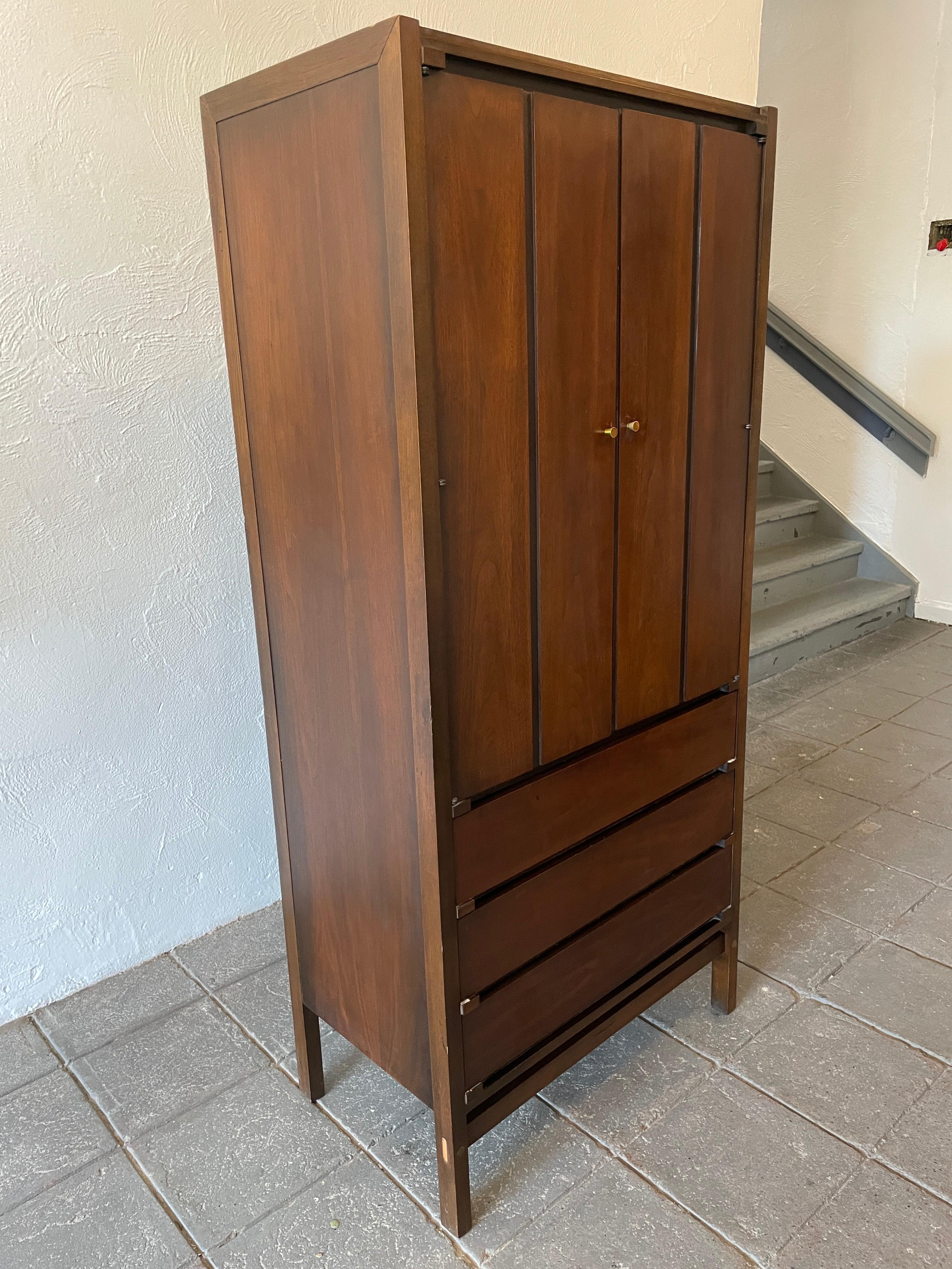 Beautiful midcentury tall walnut and black 3 drawer dresser wardrobe. Very clean all original 1 unit dresser or wardrobe with mirror. All lower drawers are clean and very smooth. Top section has 2 cabinet doors with brass knobs. In side is 1 mirror