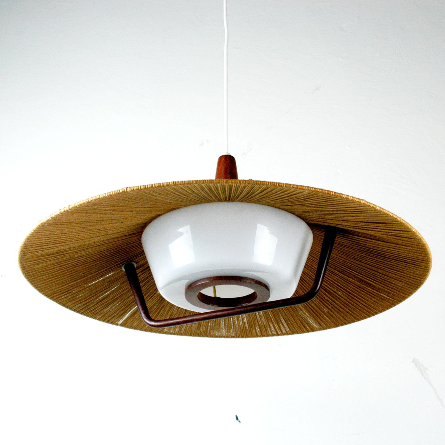 Very charming huge pendant lamp from the 1960s by the German manufacture Temde with cord shade and perspex diffuser in beautiful original condition. It has one E 27 light socket.
Total height / length of the wire can be adjusted as customer likes.