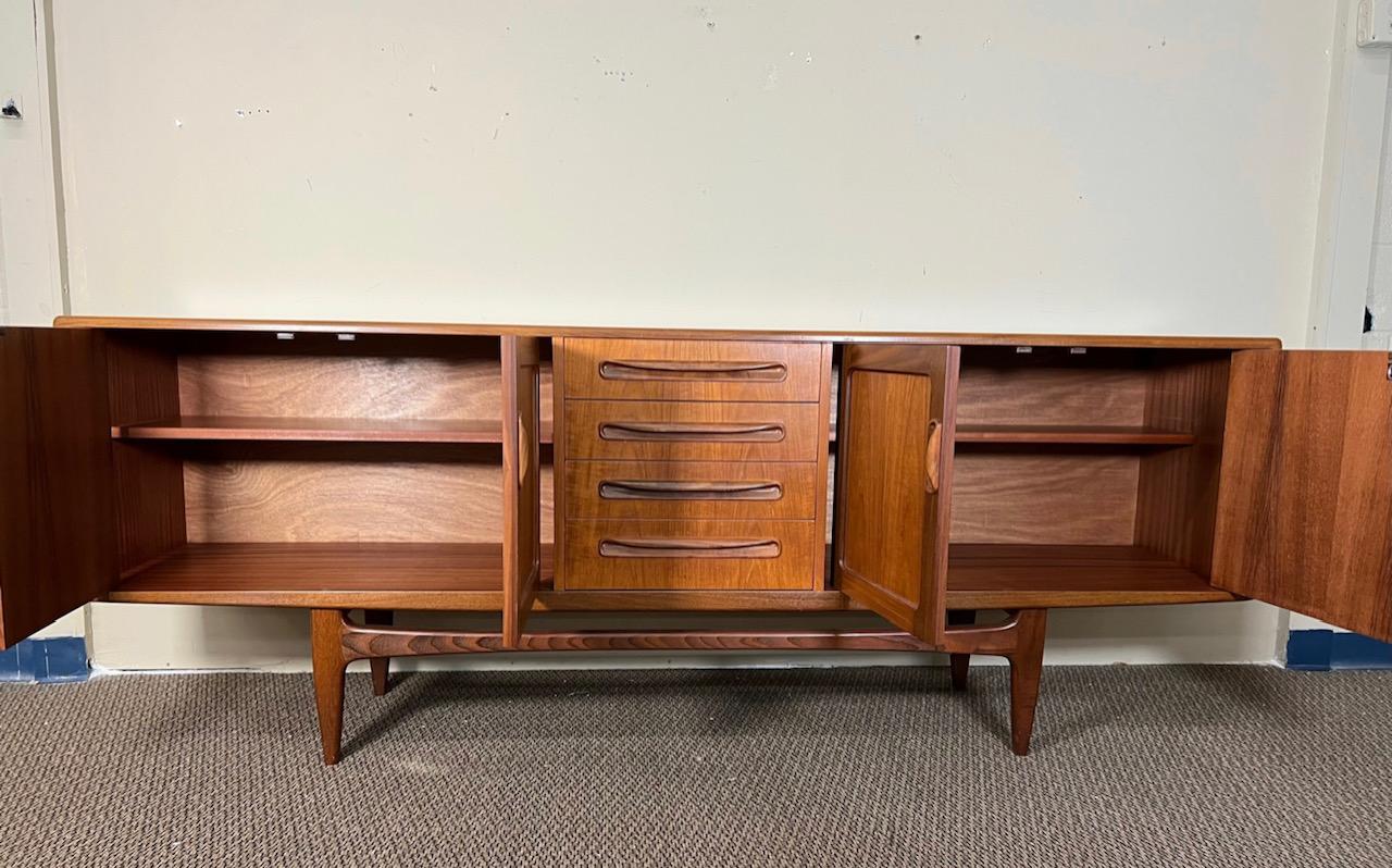 Outstanding teak credenza by G Plan from the popular Fresco Range. With original gray fabric with silverware dividers in the top drawer. Adjustable shelves. Fantastic condition. Clean drawers all open and close well. Mark on top as shown in