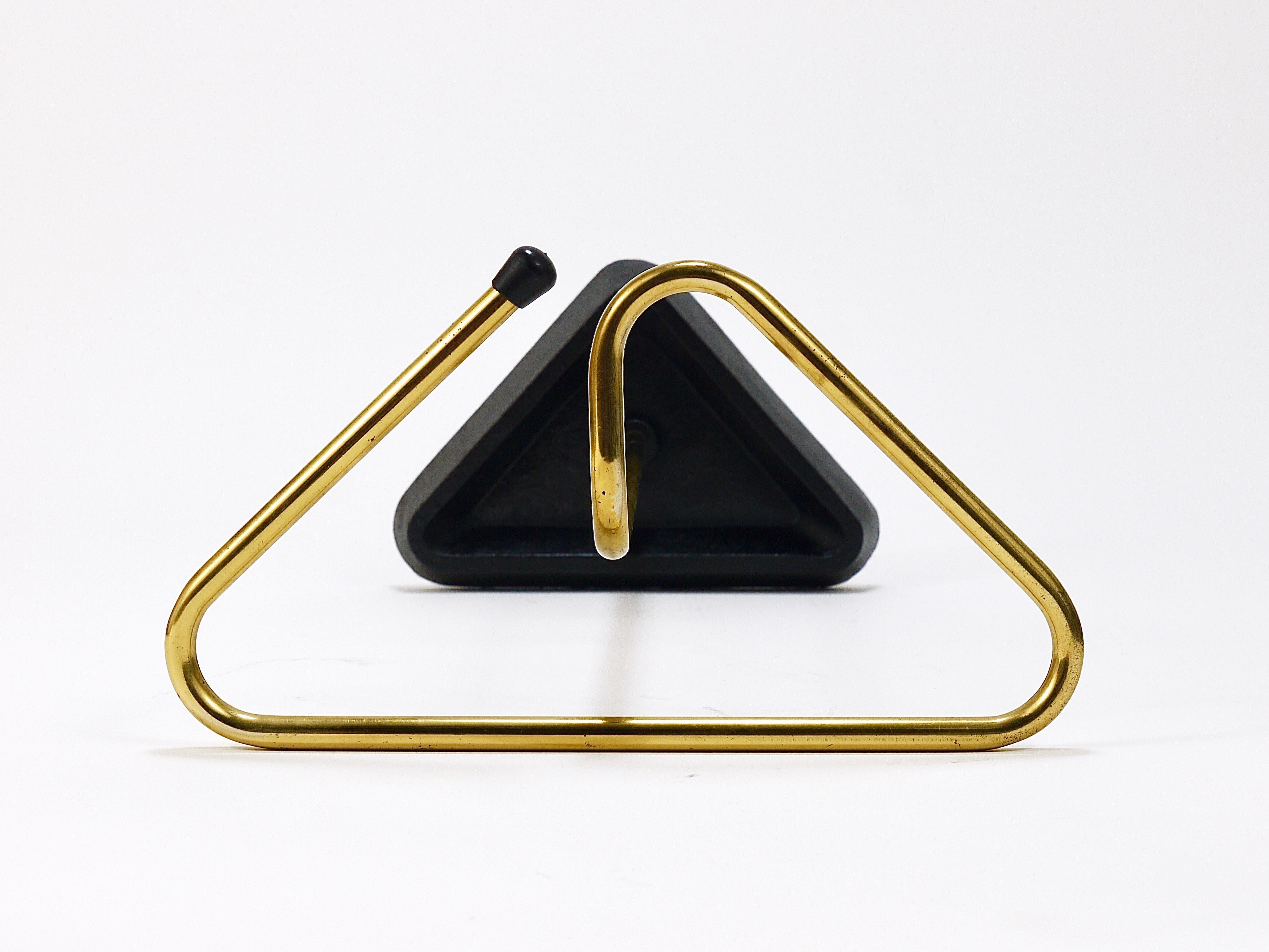A lovely Austrian modernist umbrella stand or or walking stick holder from the 1950s. Made in Vienna, Austria. Made of  brass with a solid black cast iron base. A decorative umbrella stand with a wonderful triangular shape in good condition with