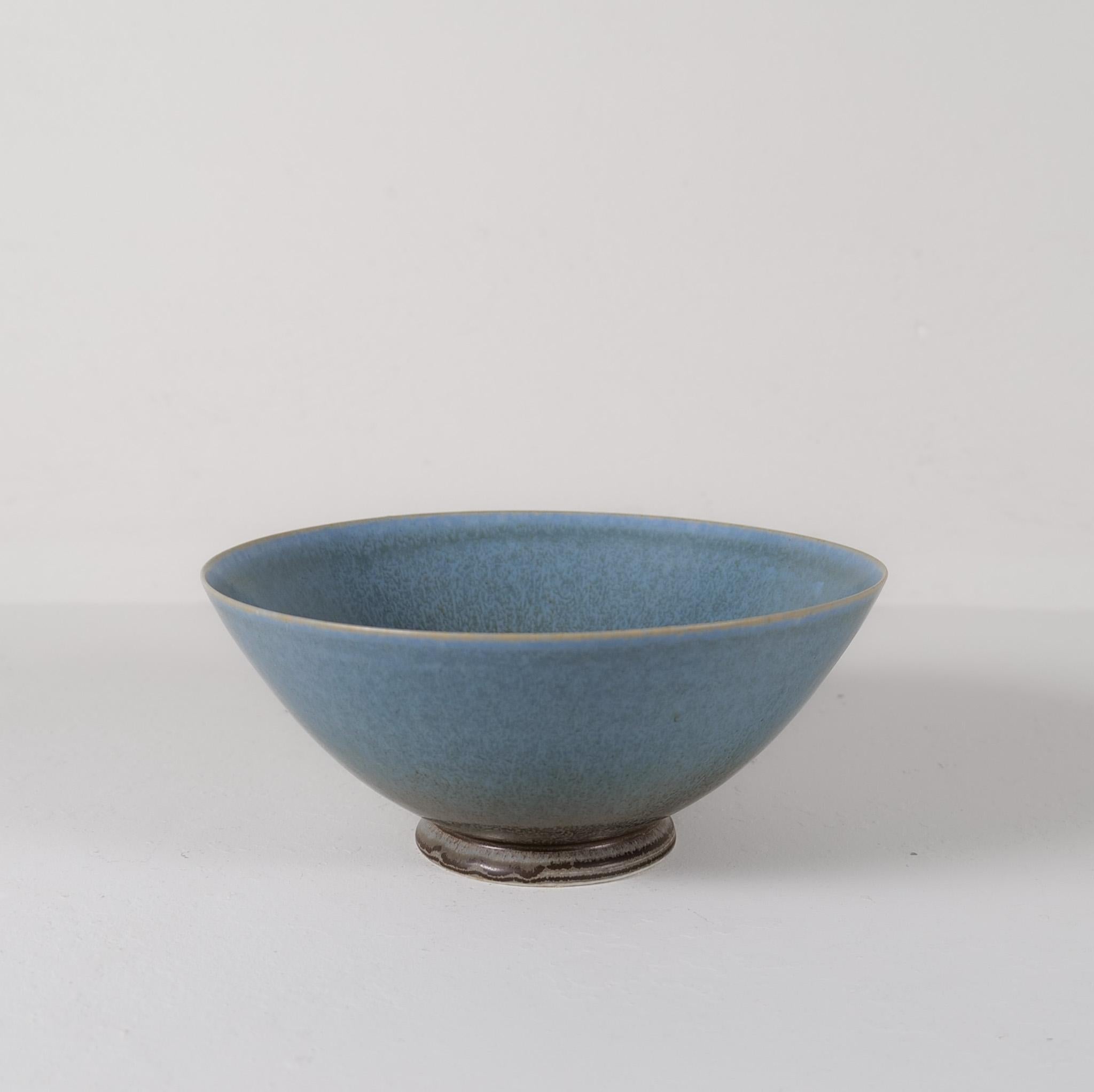 This bowl was handmade and glazed in the G-studio factory at Gustavsberg by Sven Wejsfelt. At the K-studio designers was given the spirit to produce unique art for Gustavsberg. 
The bowl is perfectly shaped and has a wonderful green /blue
