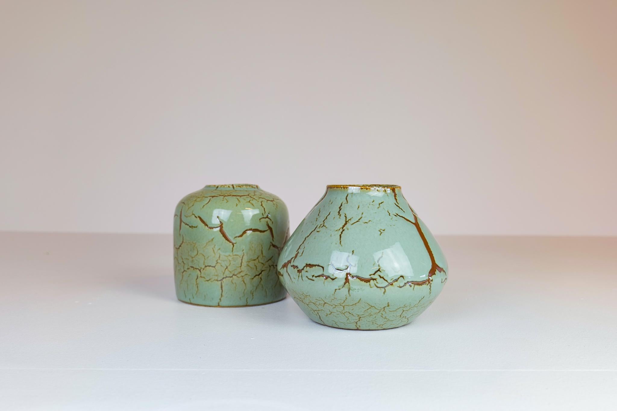 These pieces of ceramics were made in Sweden 1950s for Rörstrand and designed by one of the great ceramic’s designers from Sweden, Carl-Harry Stålhane. There is a stunning nice light green color with unique cracked brown glaze. Even though so unique