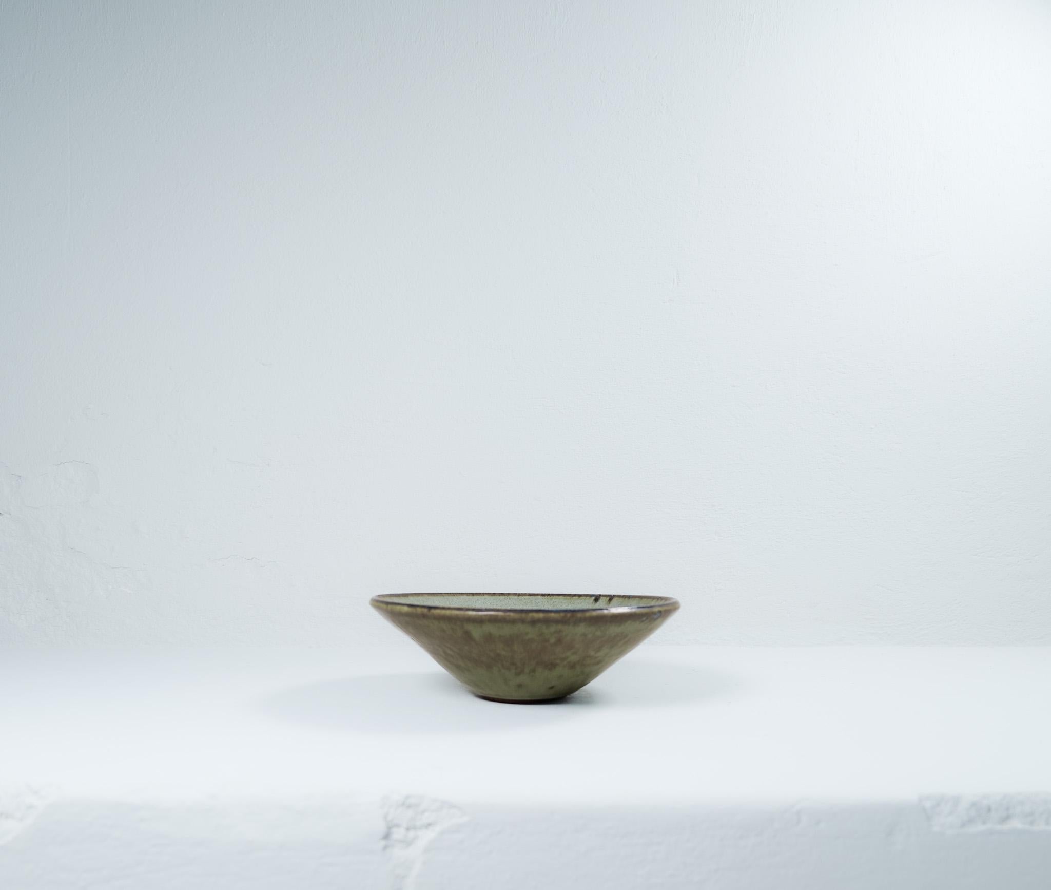 This large unique bowl has a wonderful glaze. It’s made in Sweden at Rörstrand and designed by Carl-Harry Stålhane. There is only one of its kind and is therefore a spectacular piece to have. Its stunning in its design and deep glaze pattern. Signed
