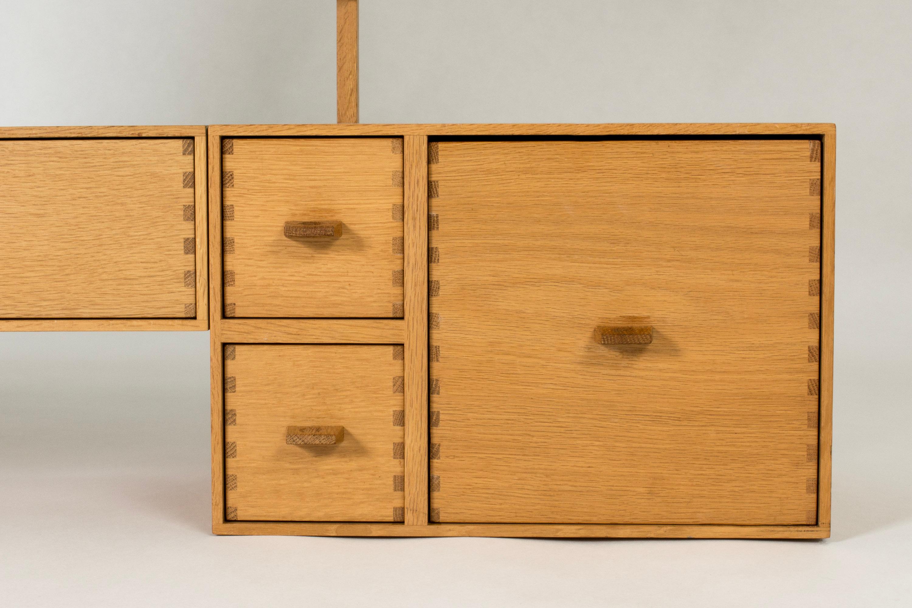 Beautiful wall dressing table by Uno and Östen Kristiansson, made from oak. Cool details in the joinery and the sculpted handles on the drawers.