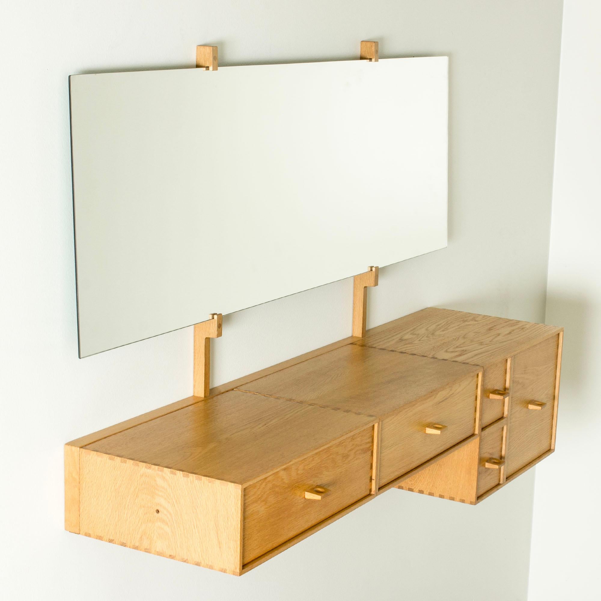 Beautiful wall dressing table by Uno and Östen Kristiansson, made from oak. Cool details in the joinery and the sculpted handles on the drawers.