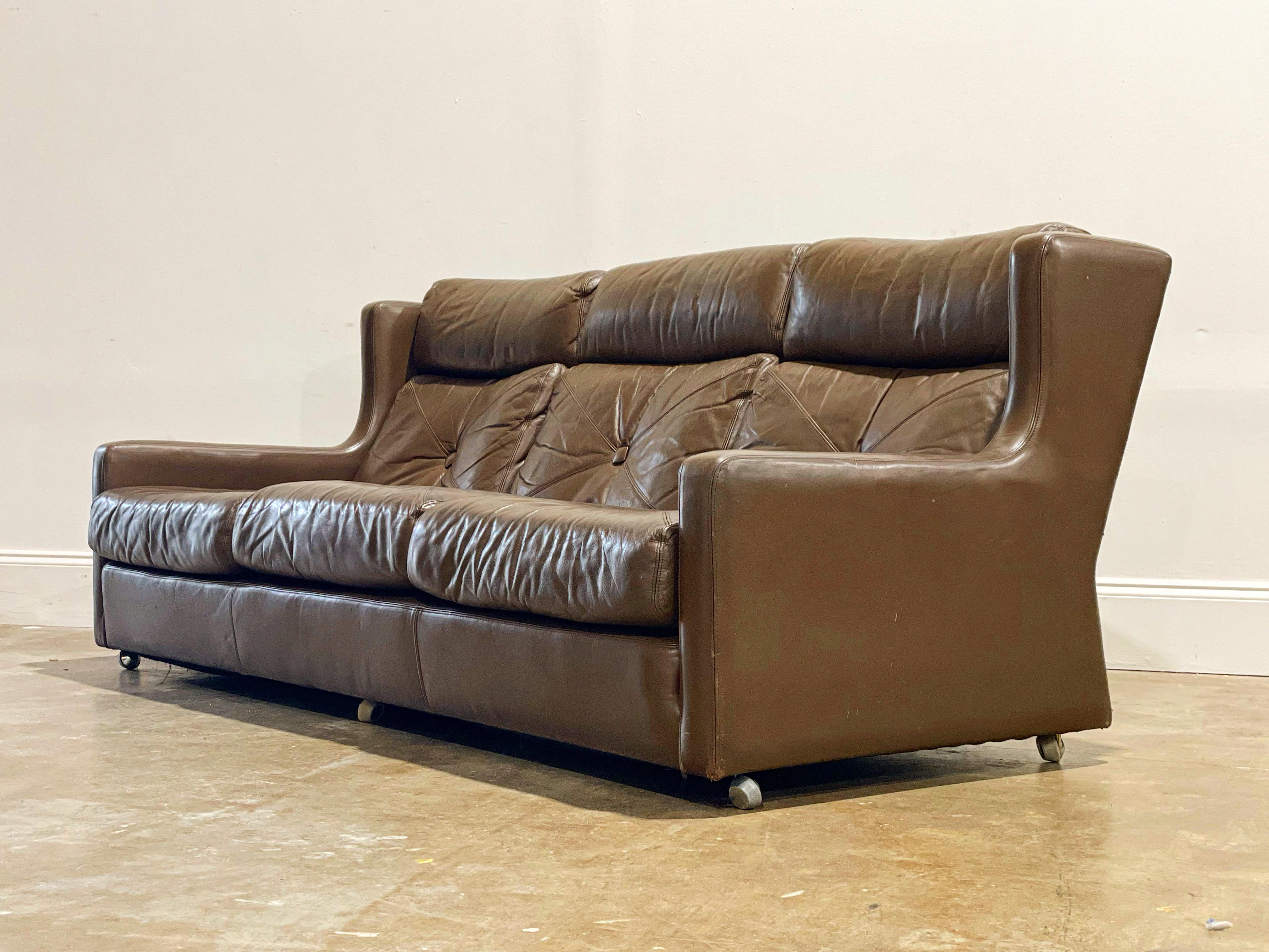Mid-Century Modern wingback leather sofa by G Plan, circa 1968. Warm chocolate brown and chrome casters. Leather is soft and supple and has aged to perfection with no issues of note. Leather has been cleaned and conditioned - this sofa is ready for