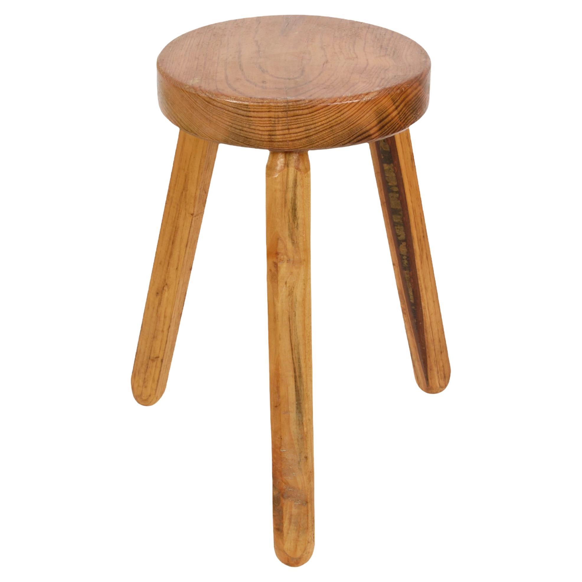 Amazing Mid-Century Modern wood French tripod stool. 

This magnificent item was produced in France during the 1950s in the style of Charlotte Perriand.

The piece is wonderful because it has clear and simple lines and will be perfect to
