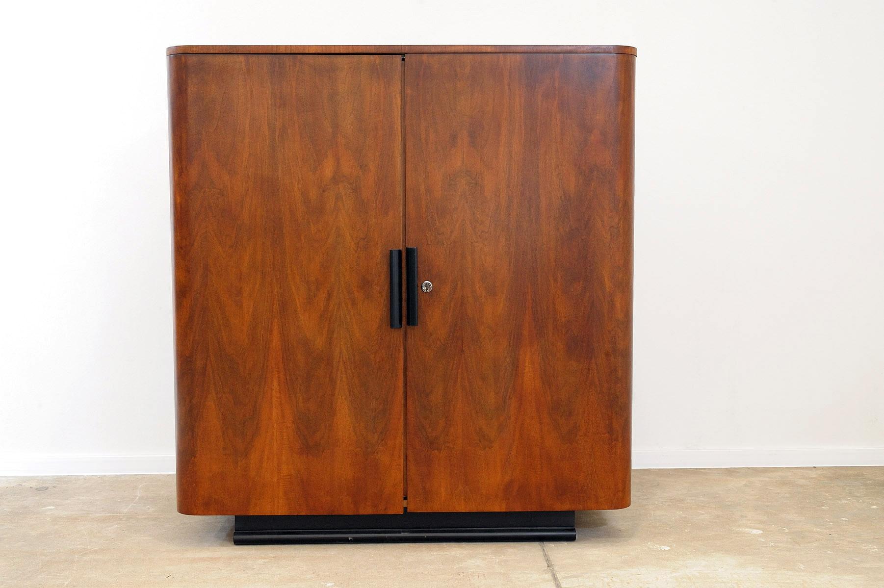 This midcentury walnut cabinet was designed by Jindřich Halabala for UP Závody.

It was part of a complete bedroom suite by UP Závody. It was made in the former Czechoslovakia in 1952.

Very simple design.

It´s in excellent condition, fully