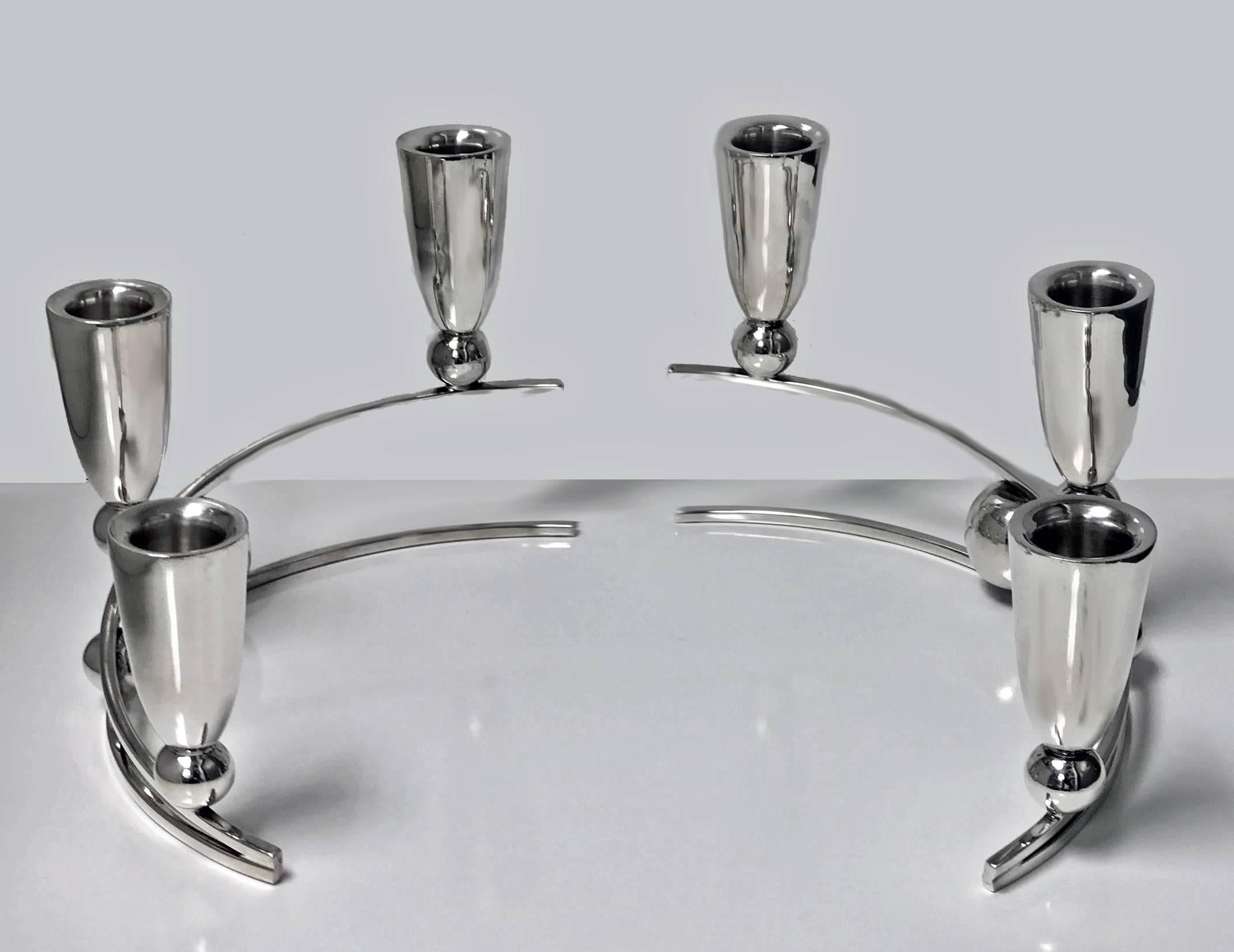 Pair of Mid-Century Modernist P Lopez G sterling candelabra candlesticks, Mexico, circa 1950. Each of a stylized curvilinear sphere style, with three vase tulip shape candleholders in each candelabrum. Marked for P. Lopez. Lopez G is a well-known