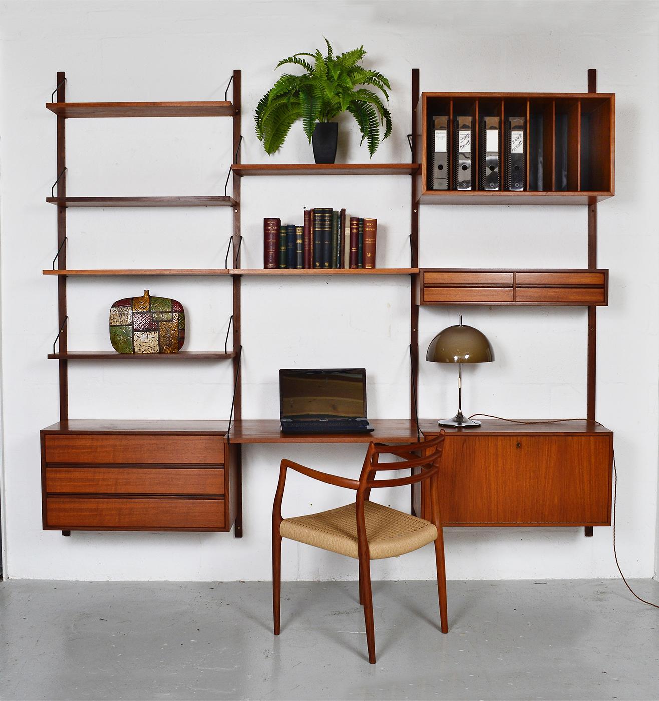 This highly versatile and functional “Royal System” was first designed in 1948 by Poul Cadovius. Offering the complete home office, and being modular, a variety of display options. The metal supports compliment the teak timber and gives this piece a