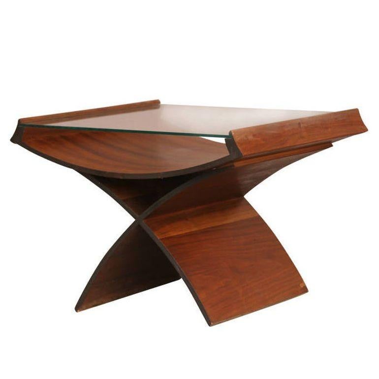Inspired by the breakthrough of the Eames designed LCD chair for Herman Miller many designer and boutiques began to experiment with furniture made through molding plywood.

This molded plywood side table is a great example of early Mid-century