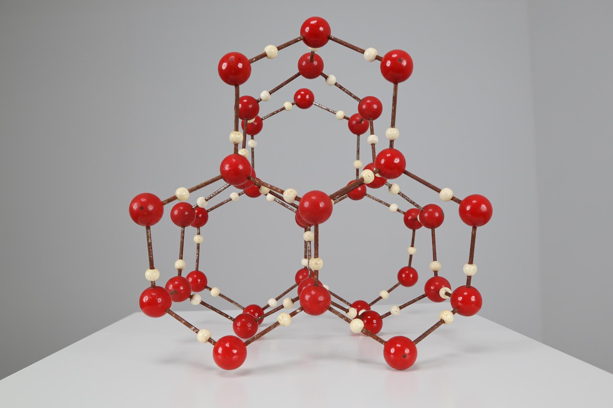 Molecular structure of water (H2O) for educational use, metal with wooden small spheres white painted, and with the larger spheres made of red painted bakelite. Czechoslovak manufacture of the 1950s. 

 