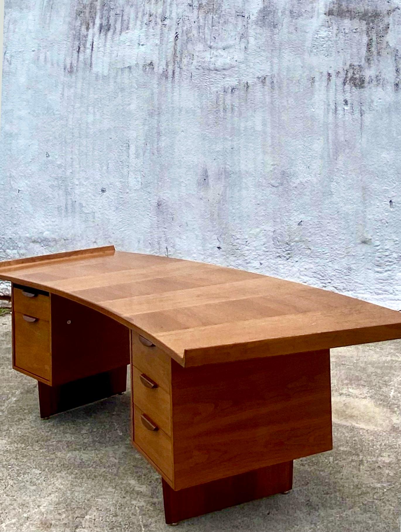 Spectacular Midcentury Harvey Probber executive desk. Impressive in size with a curved surfboard two tone top. Rests on slender blades to give the desk the appearance of floating. A real collectors piece. Acquired from a Hobe Sound estate.