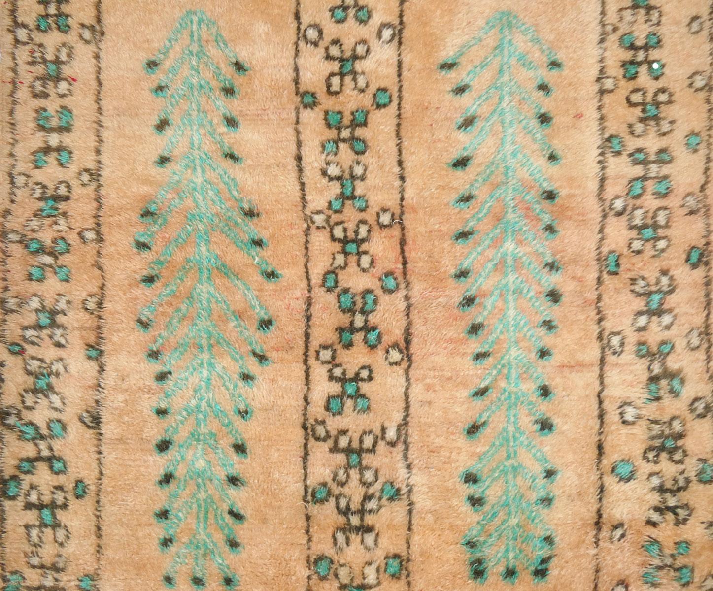 Midcentury Boujad rug handwoven with shades of honey and aqua green colored wool in an abstract pattern of Berber symbols. Circa 1960
Dimensions: 4'5 x 8'11   
Diamond or lozenge design represents fertility, feminine energy, and protection.
Abstract
