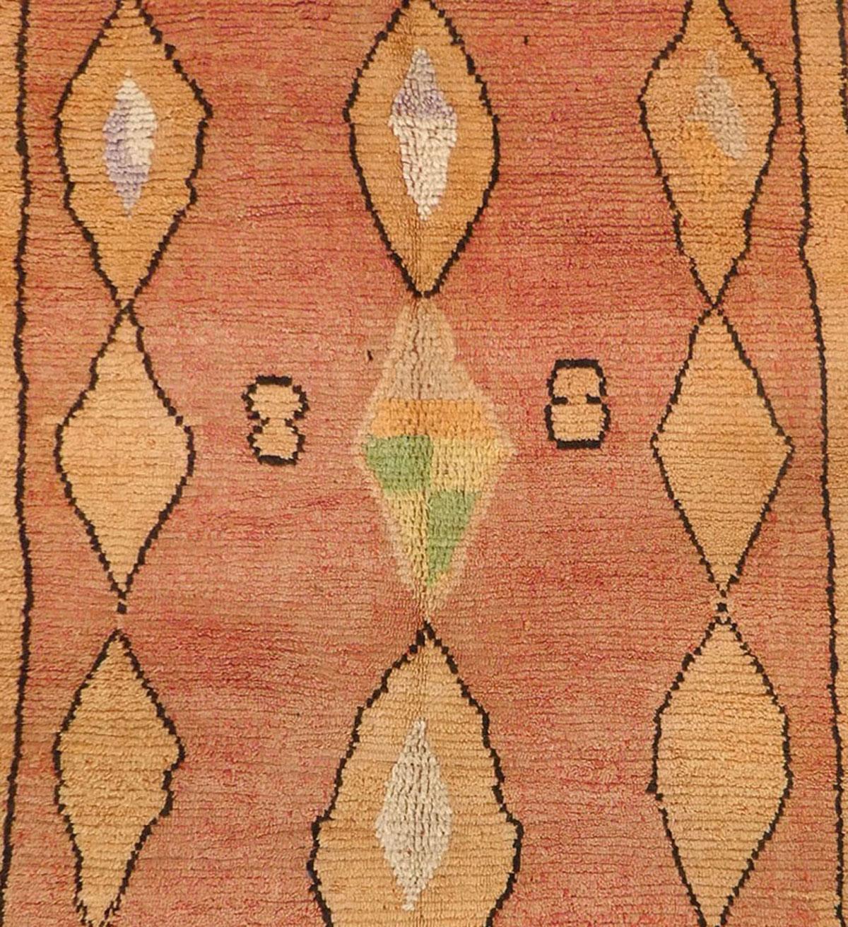 Tappeto Boujad della metà del secolo scorso, tessuto a mano con tonalità di lana color terracotta, miele e verde in un motivo astratto di simboli berberi. Circa 1960
Dimensioni: 5'10 x 9'   
Il disegno del diamante o della losanga rappresenta la