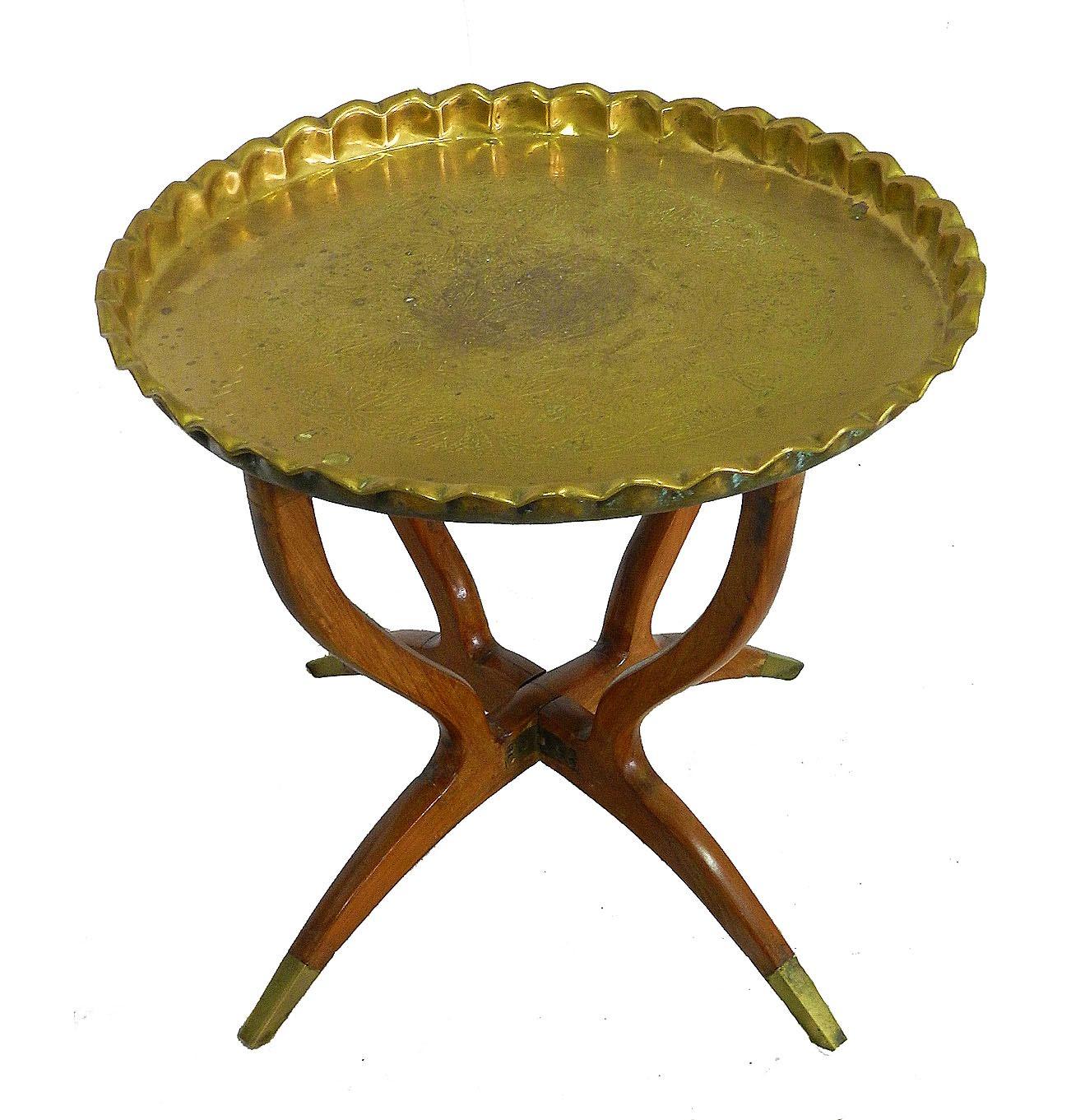 Round brass tray table Morocco
Polished brass tray standing on folding mahogany base with four legs and brass finals.
Mid-Century Modern polished brass tray table.
Moorish hand-hammered brass tray pie crust edge
The tray is finely chased,