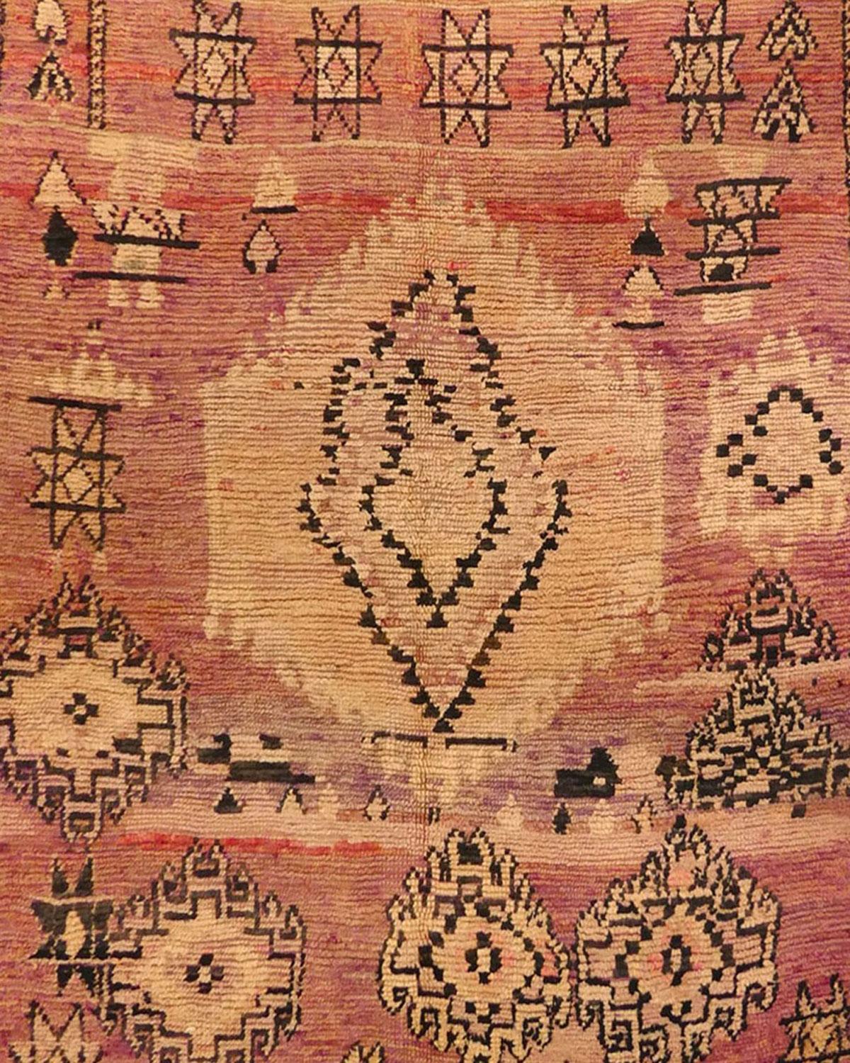 Midcentury Boujad rug handwoven with shades of terracotta, honey and green colored wool in an abstract pattern of Berber symbols. Circa 1960
Dimensions: 5'10 x 9'   
In Berber culture and the artistry of weaving rugs, abstract patterns often reflect