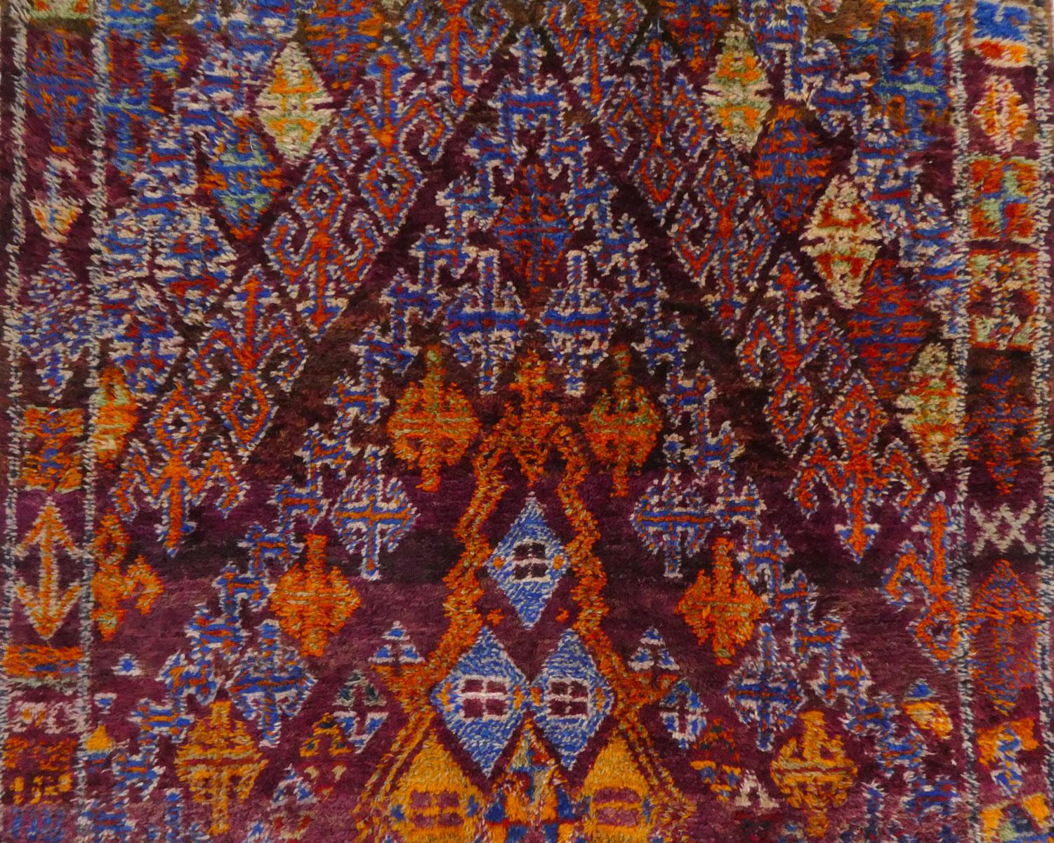Moroccan Zayan rug handwoven with indigo, orange and magenta wool in an elaborate Berber symbol design. Circa 1970
Dimensions: 5'7