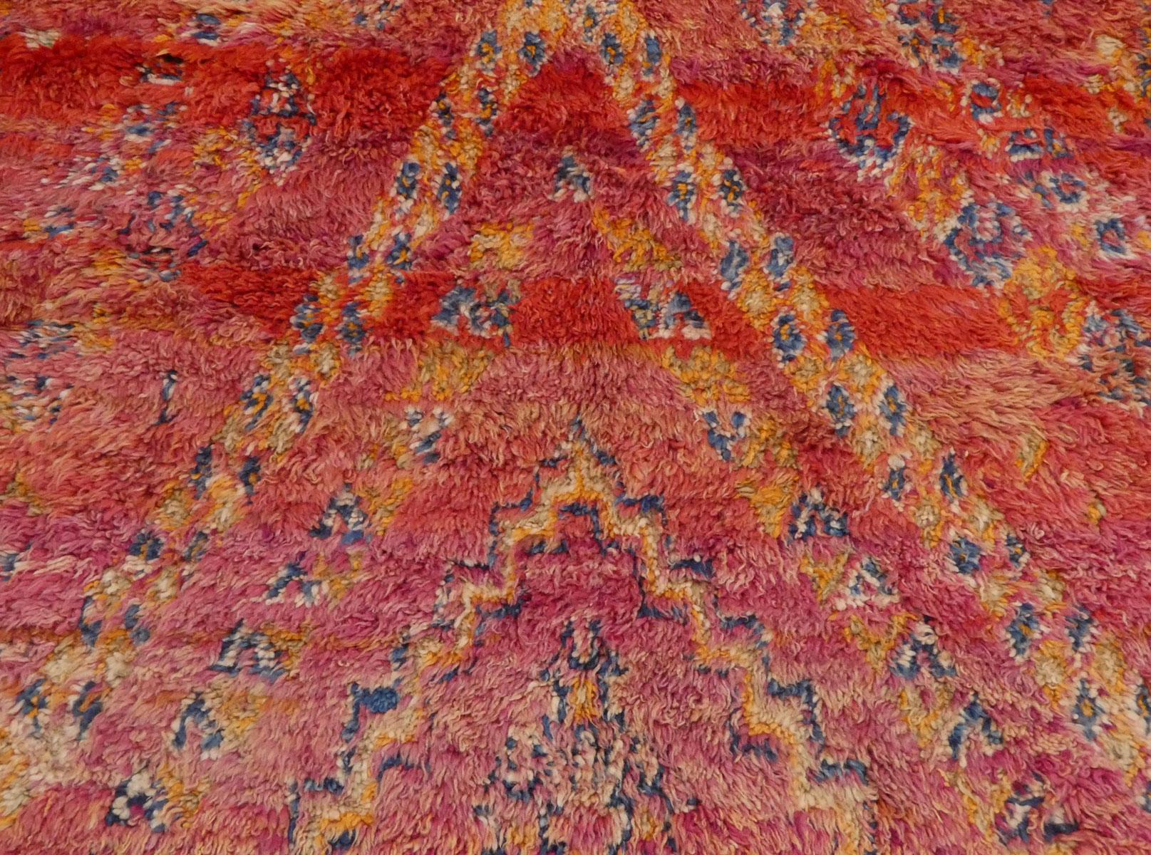 Moroccan Zayane rug handwoven with red, fuchsia, indigo and orange wool in an elaborate Berber symbol design, excellent condition. Circa 1970

Dimensions: 6'6 X 9'8

Zayane rugs originate from the Khénifra region in the Moroccan Middle Atlas