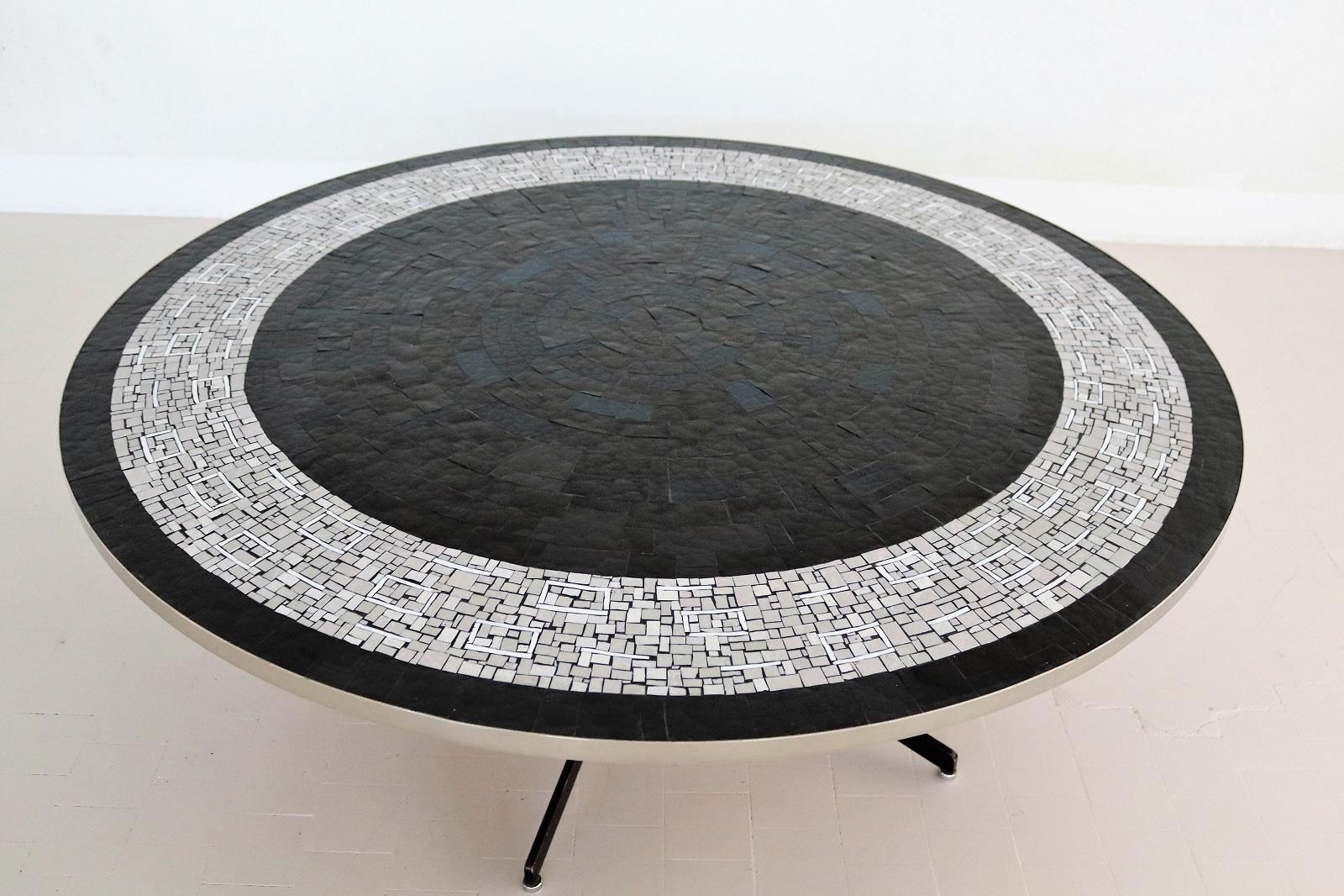 Gorgeous big coffee table with big mosaic plate with black, dark blue, grey and white tiles on strong table base.
Made in Germany in the 1960s by Berthold Müller, Oerlighausen.
The edge of the table plate is made of stainless steel and are