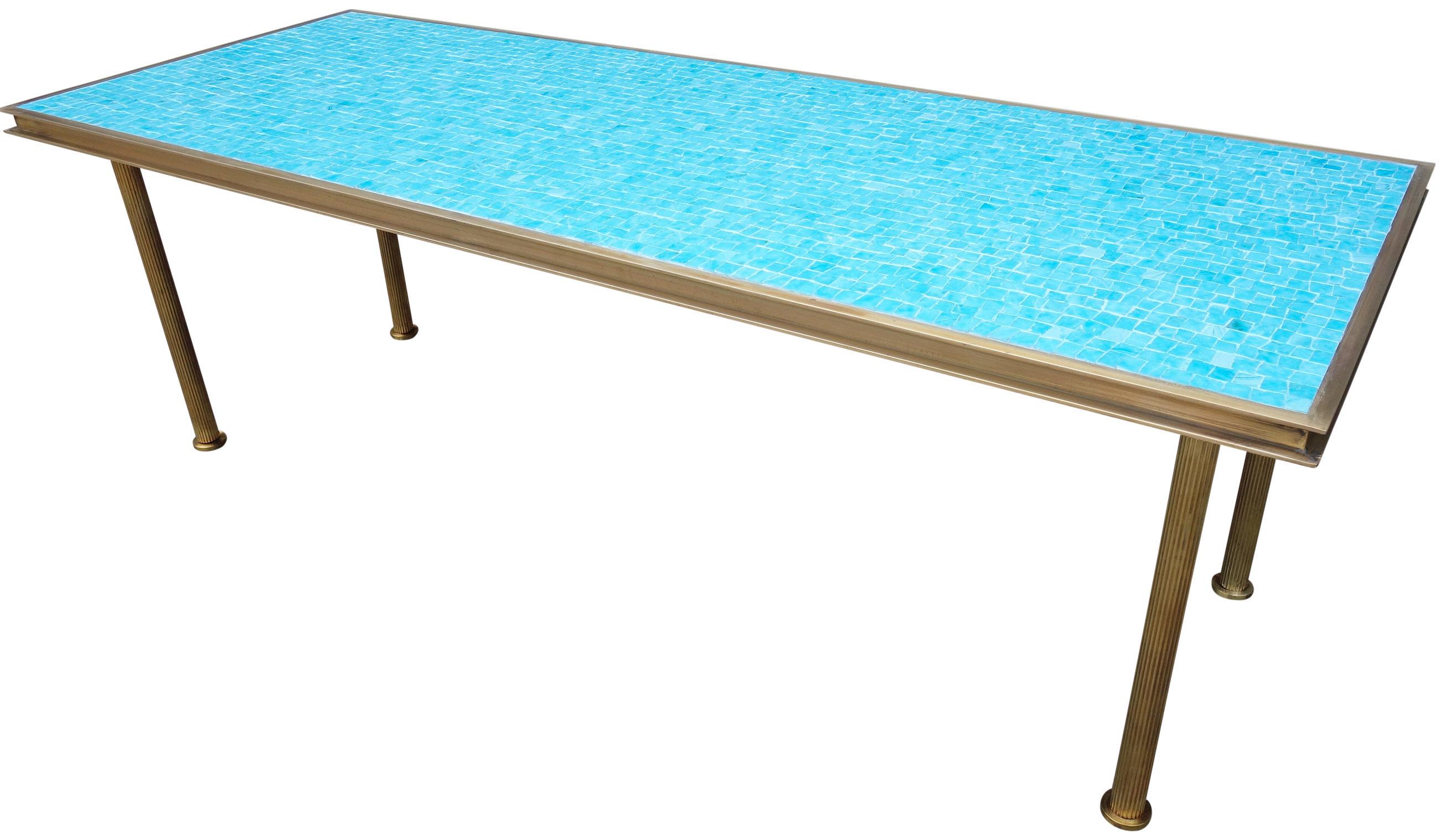 For your consideration is this beautiful glass mosaic coffee table on a solid brass frame with fluted legs in the style of Dunbar. Featuring a wonderful turquoise / Mediterranean blue colored mosaic that will highlight your space with a midcentury