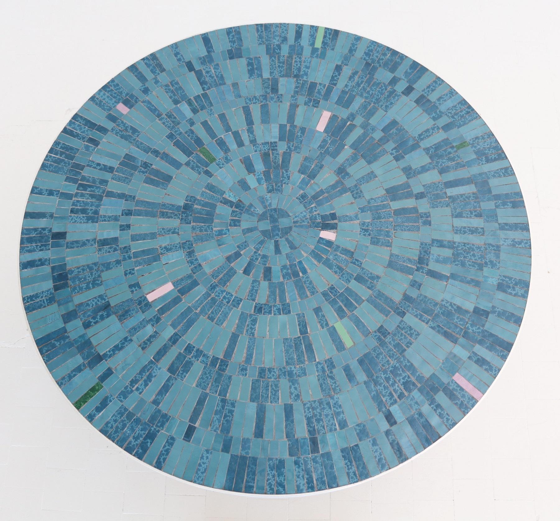 Gorgeous coffee table with beautiful Mosaic of tiles in various colors of blue, green and pink on strong table base.
Made in Germany in the 1960s by Berthold Müller Mosaikwerkstatt, Oerlighausen
The rim of the top is made of metal and the square