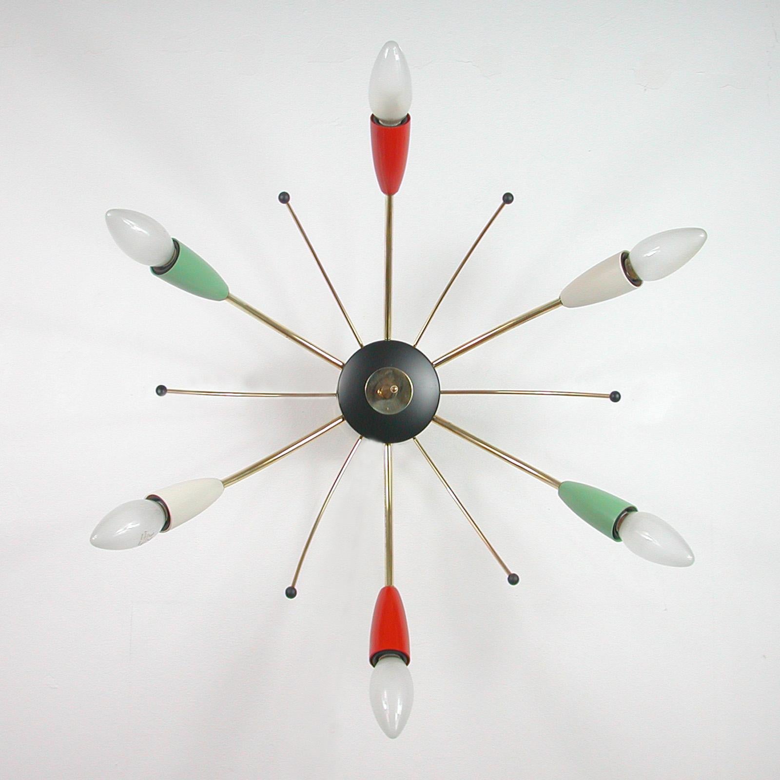 This Mid-Century Modern Sputnik light was designed and manufactured in Germany in the 1950s. It is made of brass and black lacquered metal with different colored (pale green, red and cream) plastic bulb holders and has got six lights.

Each bulb