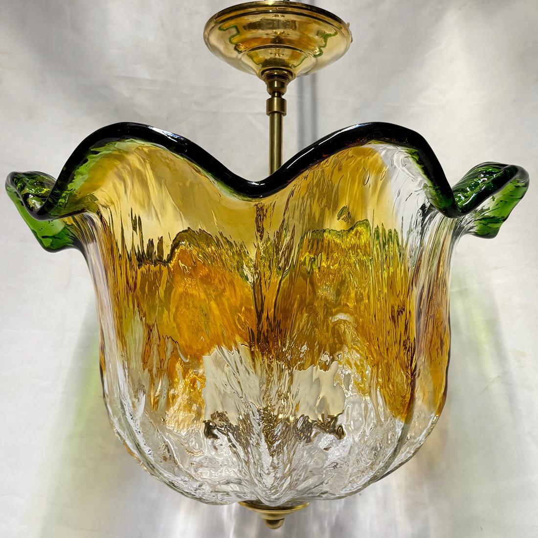 A circa 1960's Italian blown glass light pendant fixture with 6 candelabra interior lights.

Measurements:
Drop: 17