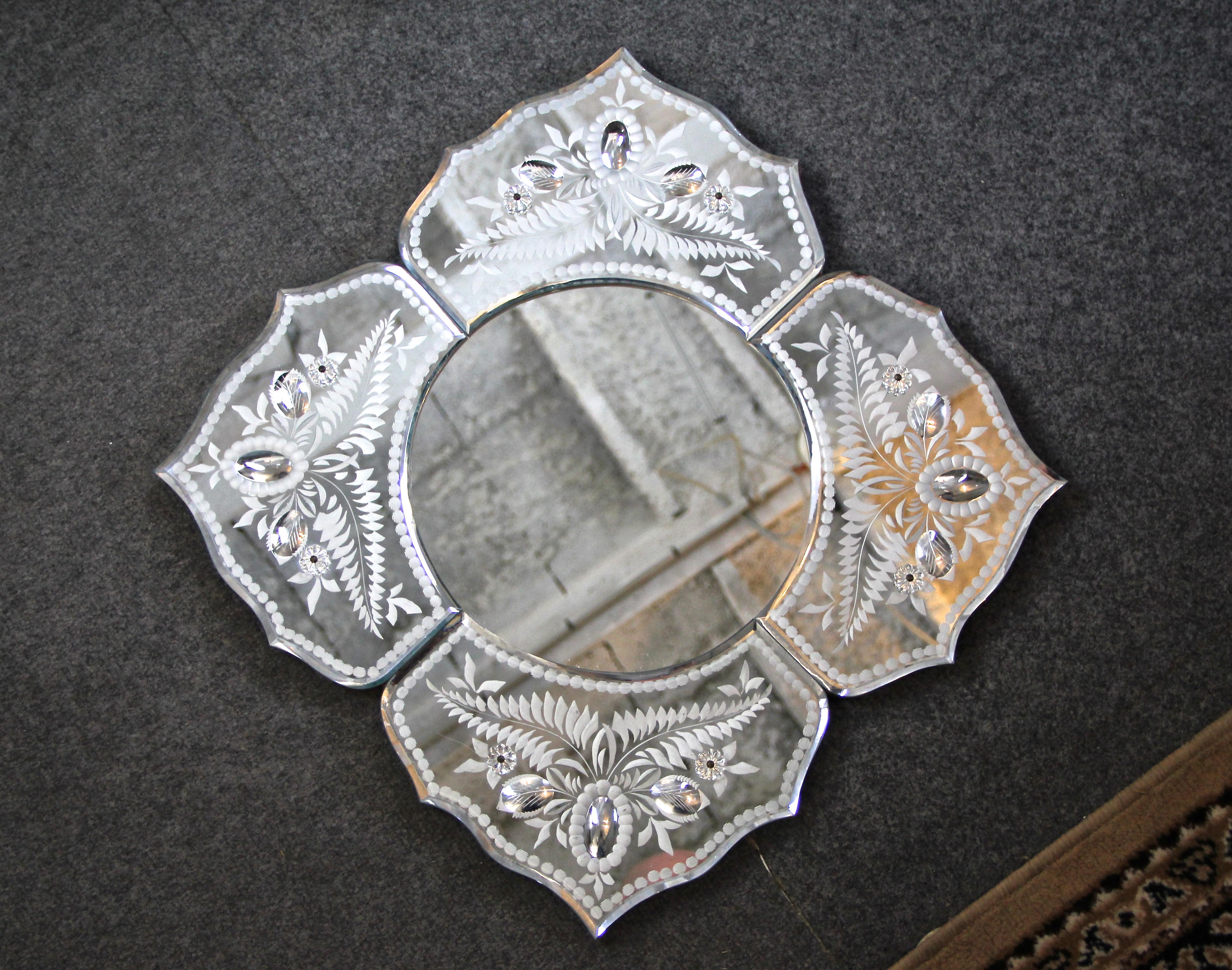 Unique Murano glass mirror from the midcentury in Italy, circa 1950-1960. The mirror´s base was made of wood and comes with a wonderful shape. A round mirror in the middle is adorned by four artfully designed and engraved Murano glass elements which