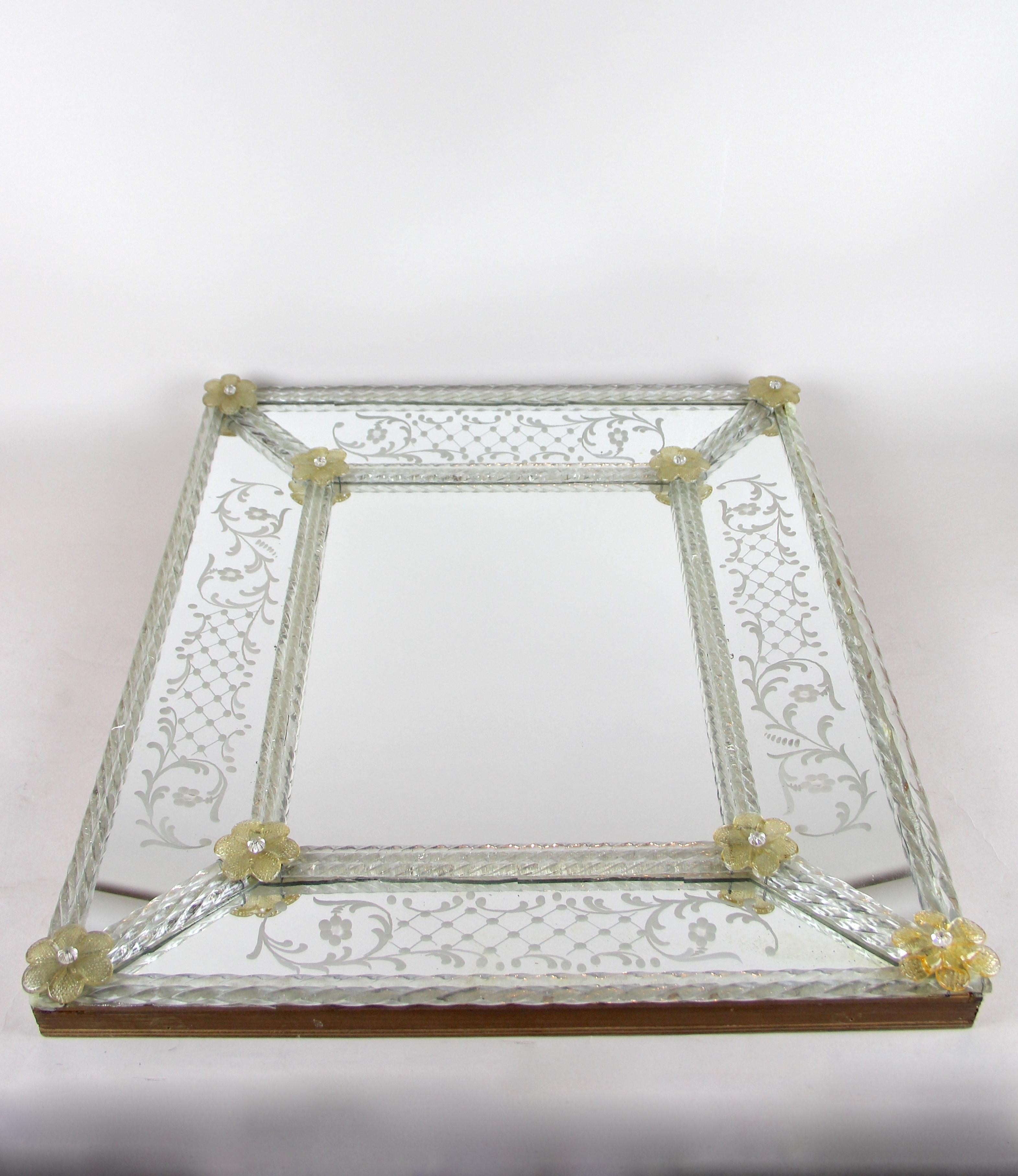 Breathtaking midcentury Murano glass mirror out of the famous workshops in Italy from circa 1950. The rectangular mirror in the middle is surrounded by four slightly inclined Murano mirror glass elements showing artfully engraved designs. Each field
