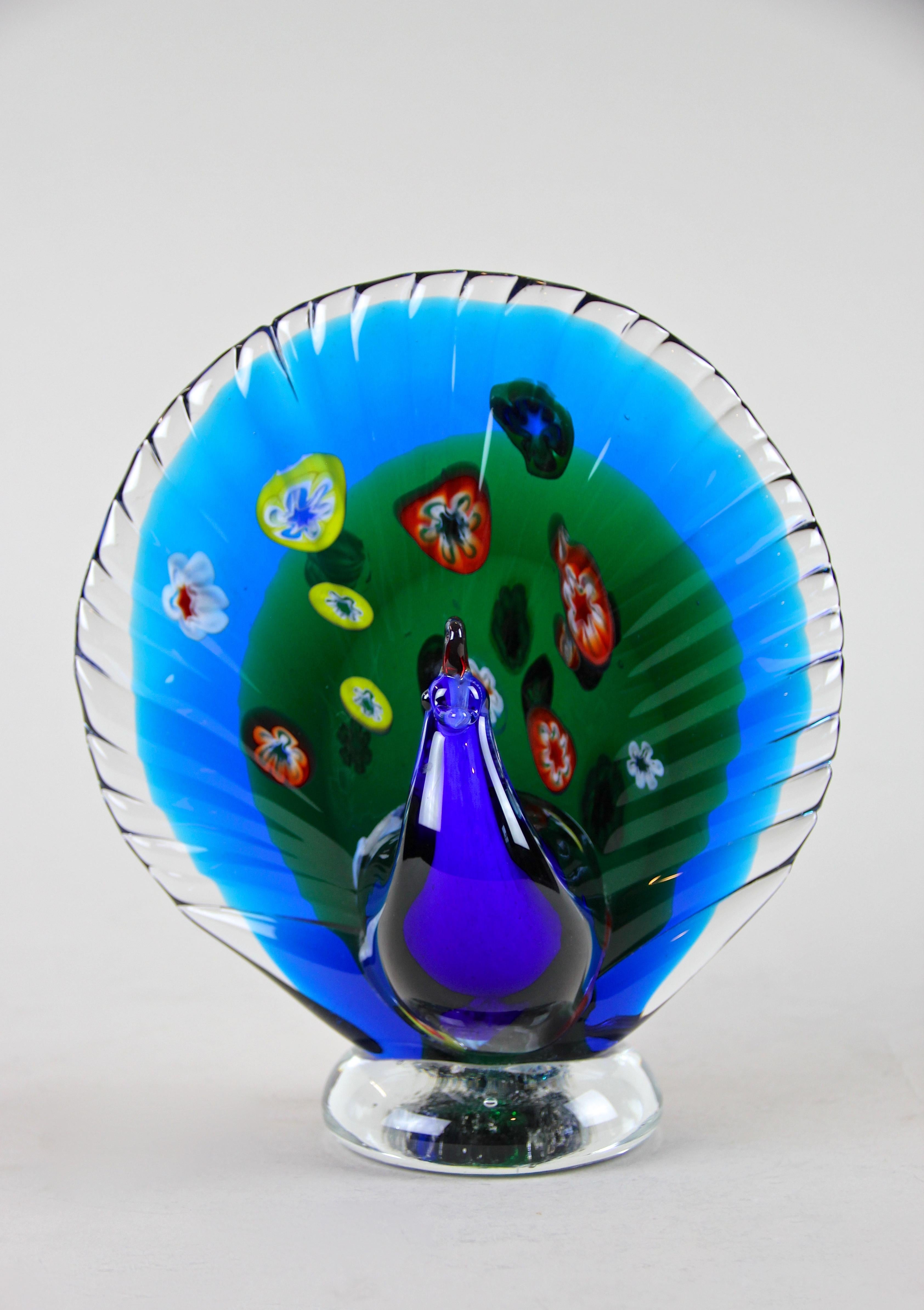 Lovely rare midcentury Murano glass peacock out of Italy. Coming from the 1960s this Murano animal sculpture impresses with an incredible design in shining blue and green tones. Additionally red, white, yellow and green flowers were set in the