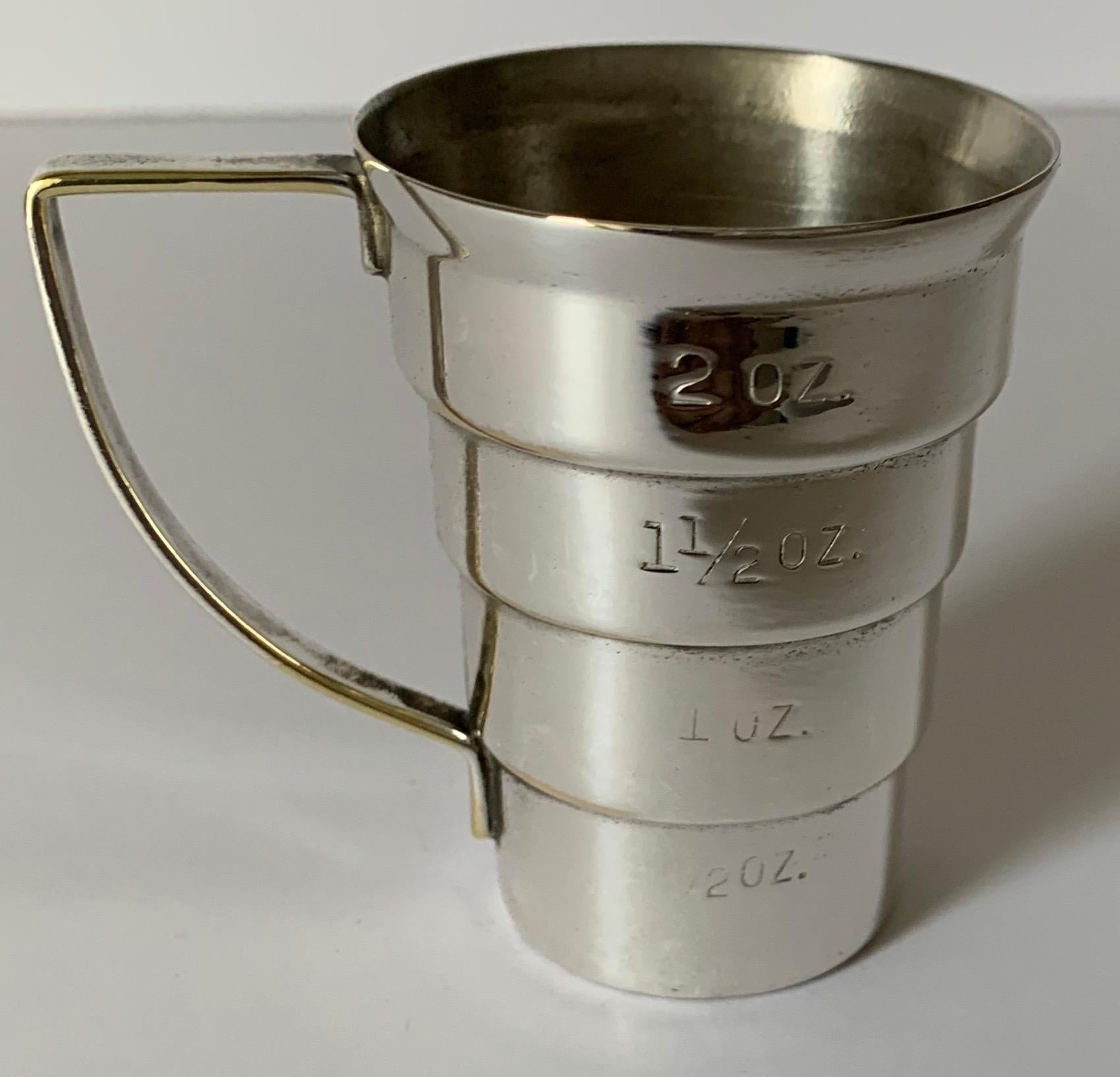 Midcentury silver plated stepped jigger by Napier. Signed on the inside of handled. Newly professionally polished to a high shine. There is light overall age related wear.