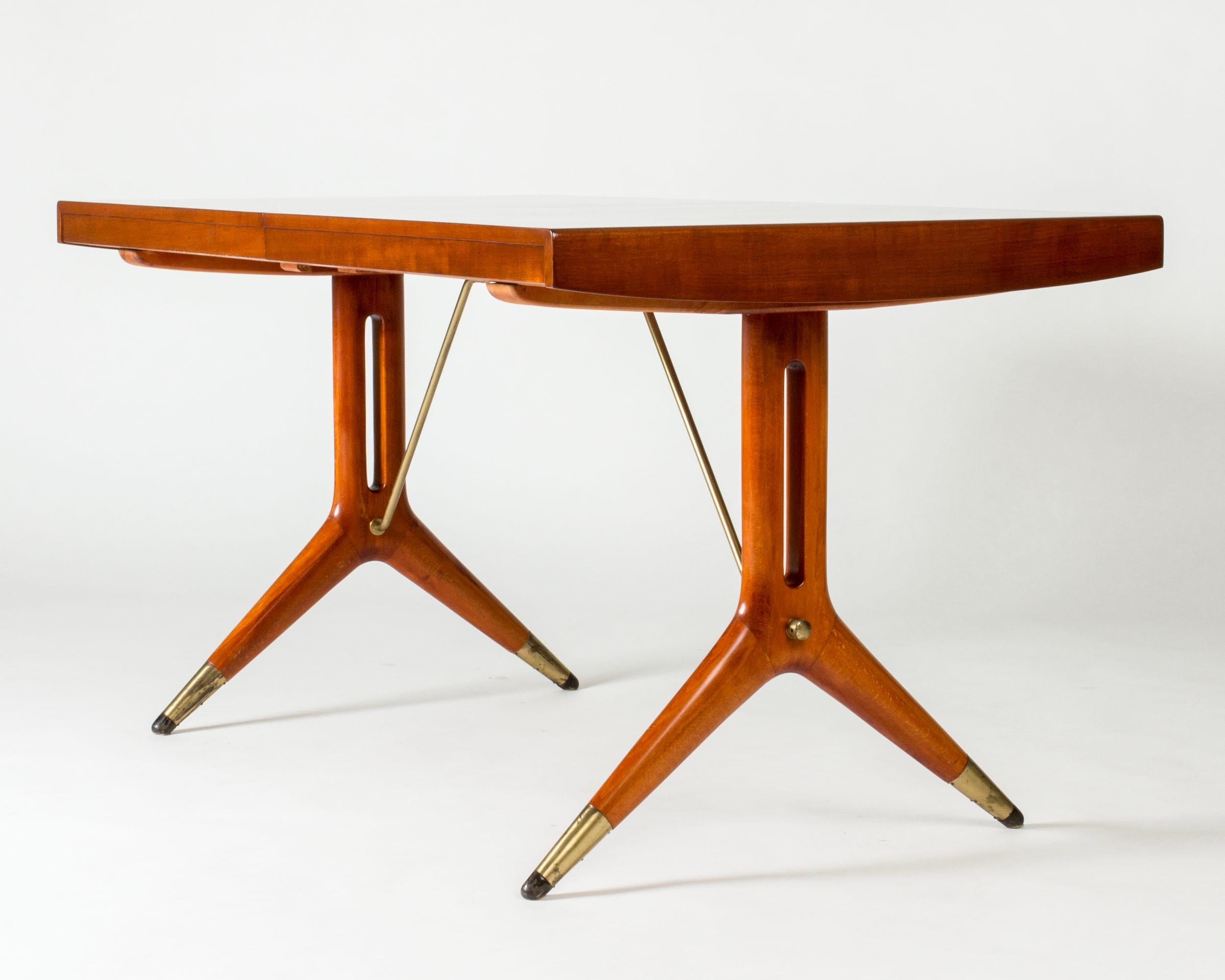 Beautiful “Napoli” dining table by David Rosén. Mahogany tabletop and elegantly sculpted legs with brass details. Two extra leaves make this a versatile table that looks great in all lengths.

The length of the table without extensions is 145 cm,